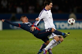 PARIS, FRANCE - NOVEMBER 05: Marco Verratti of PSG (L) tackles Sacha Kljestan of Anderlect during the UEFA Champions League Group C match between Paris Saint Germain and RSC Anderlecht at Parc des Princes on November 5, 2013 in Paris, France.  (Photo by H