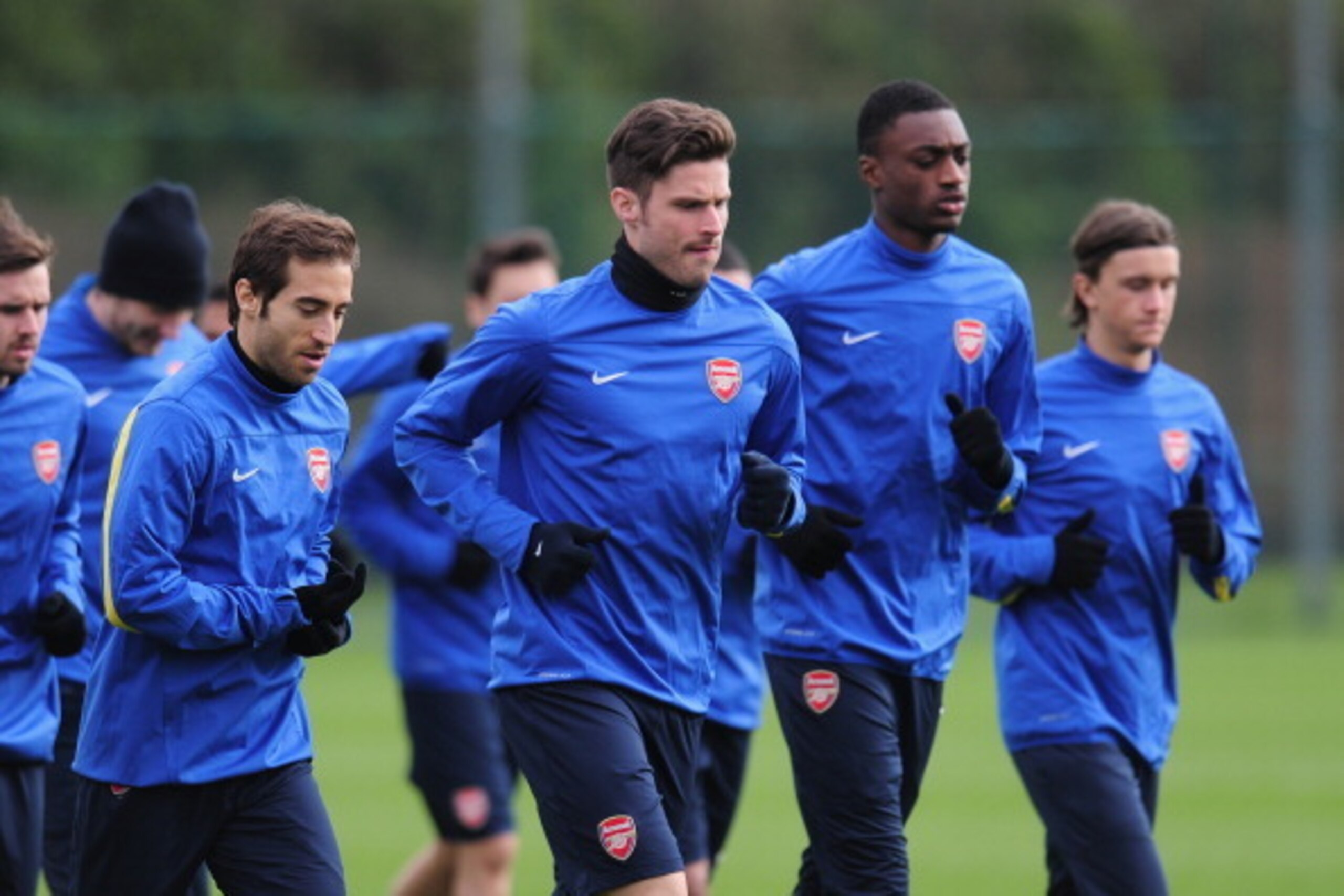ST ALBANS, ENGLAND - FEBRUARY 18:  Olivier Giroud and Mathieu Flamini warm up during a training session at London Colney on February 18, 2014 in St Albans, England.  (Photo by Shaun Botterill/Getty Images)