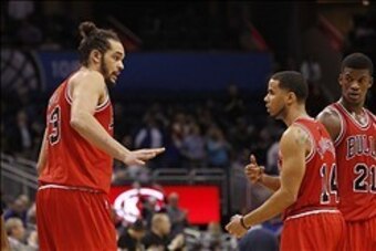 Jan 15, 2014; Orlando, FL, USA; Chicago Bulls center Joakim Noah (13), point guard D.J. Augustin (14) and shooting guard Jimmy Butler (21) talk against the Orlando Magic during the second half at Amway Center. Chicago Bulls defeated the Orlando Magic 128-