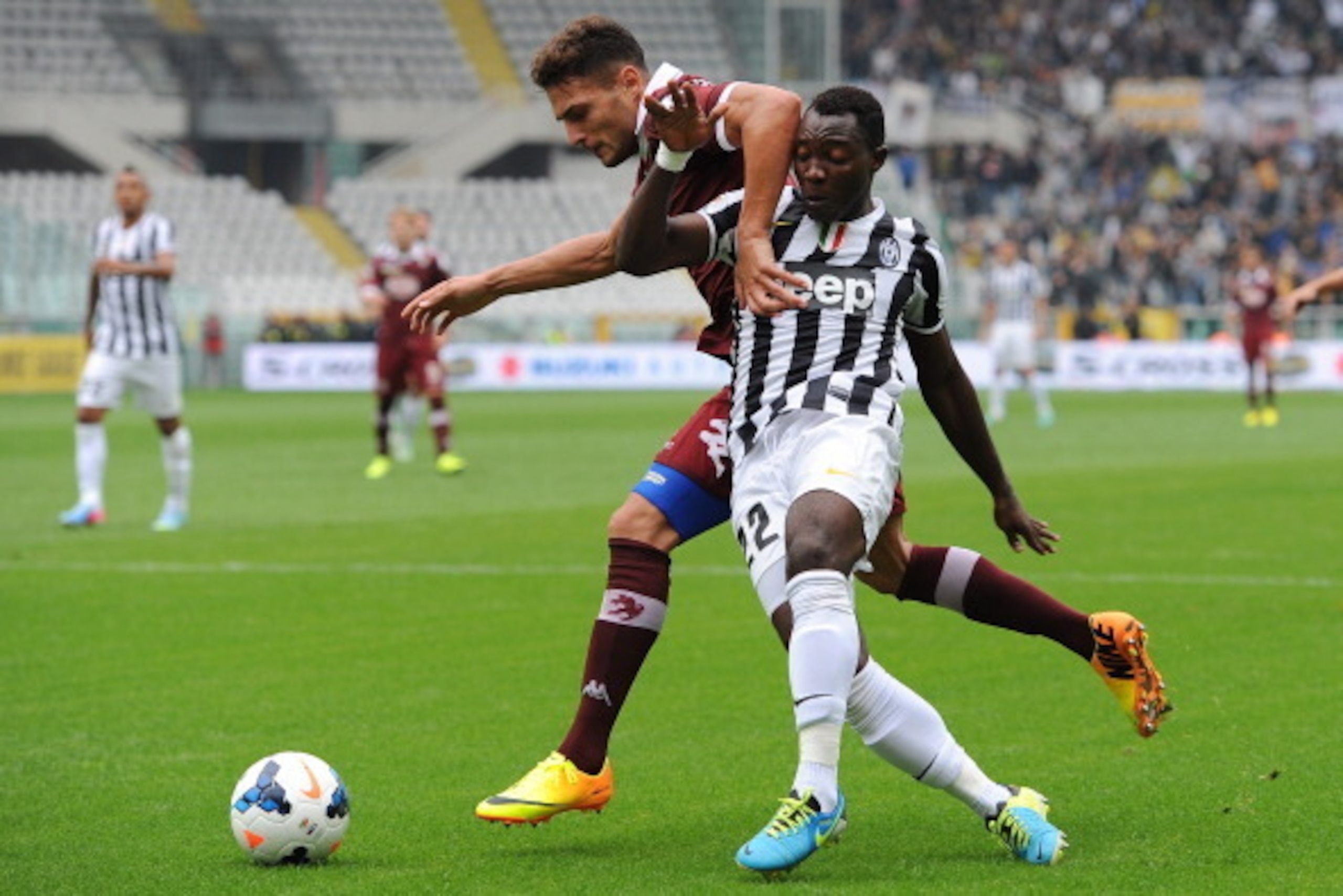TURIN , ITALY - SEPTEMBER 29:  Danilo D Ambrosio (L) of Torino FC competes with Kwadwo Asamoah of Juventus during the Serie A match between Torino FC and Juventus at Stadio Olimpico di Torino on September 29, 2013, in Turin, Italy.  (Photo by Valerio Penn