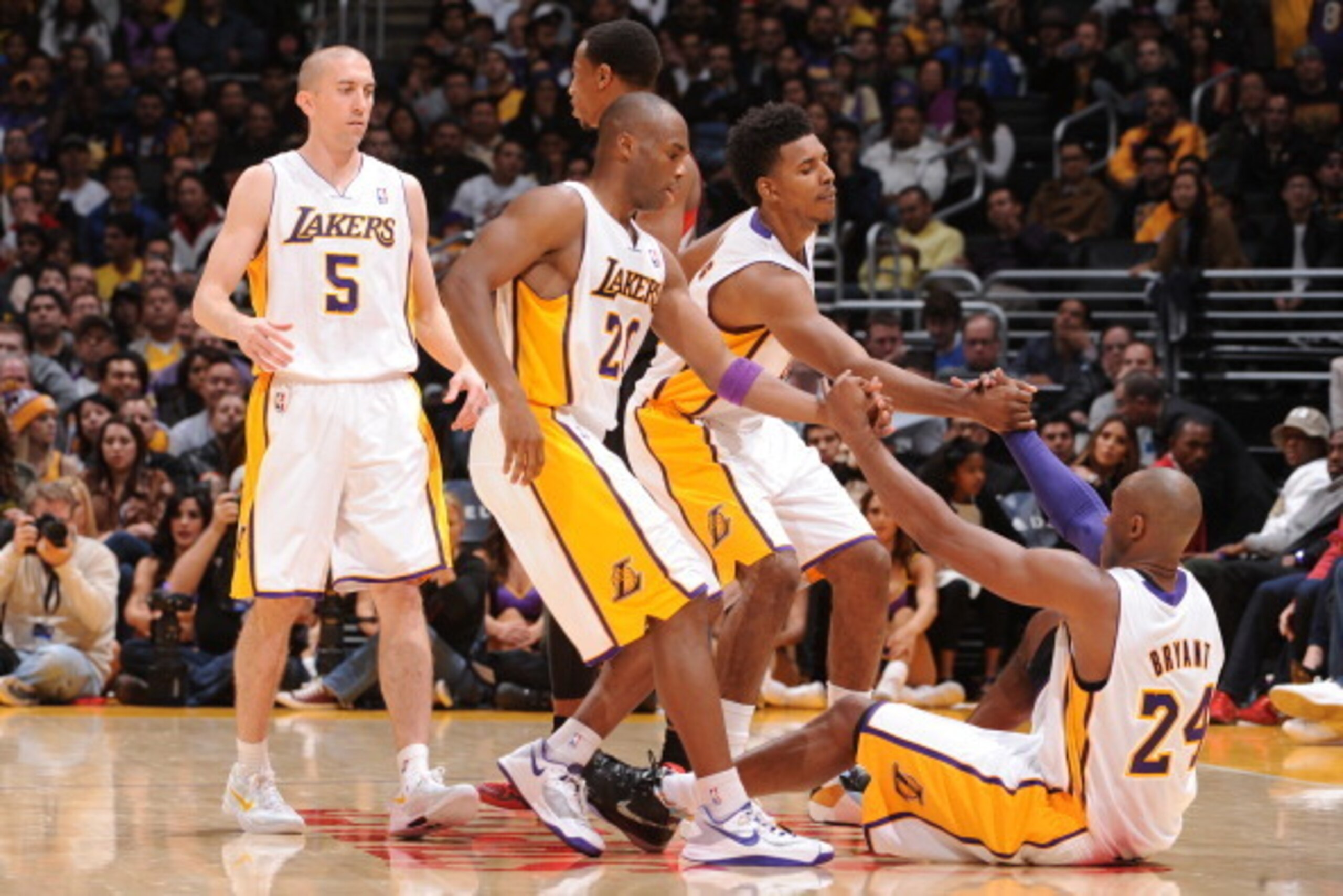 LOS ANGELES, CA - DECEMBER 8: Nick Young #0 and Jodie Meeks #20 help Kobe Bryant #24 of the Los Angeles Lakers up during a game against the Toronto Raptors on December 8, 2013 at STAPLES Center in Los Angeles, California. NOTE TO USER: User expressly ackn LOS ANGELES, CA - DECEMBER 8: Nick Young #0 and Jodie Meeks #20 help Kobe Bryant #24 of the Los Angeles Lakers up during a game against the Toronto Raptors on December 8, 2013 at STAPLES Center in Los Angeles, California. NOTE TO USER: User expressly ackn