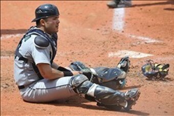 May 19, 2013; Cleveland, OH, USA; Seattle Mariners catcher Jesus Montero (63) sits behind home plate after Cleveland Indians shortstop Mike Aviles (not pictured) scored from second base on a ground out in the fourth inning at Progressive Field. Mandatory 