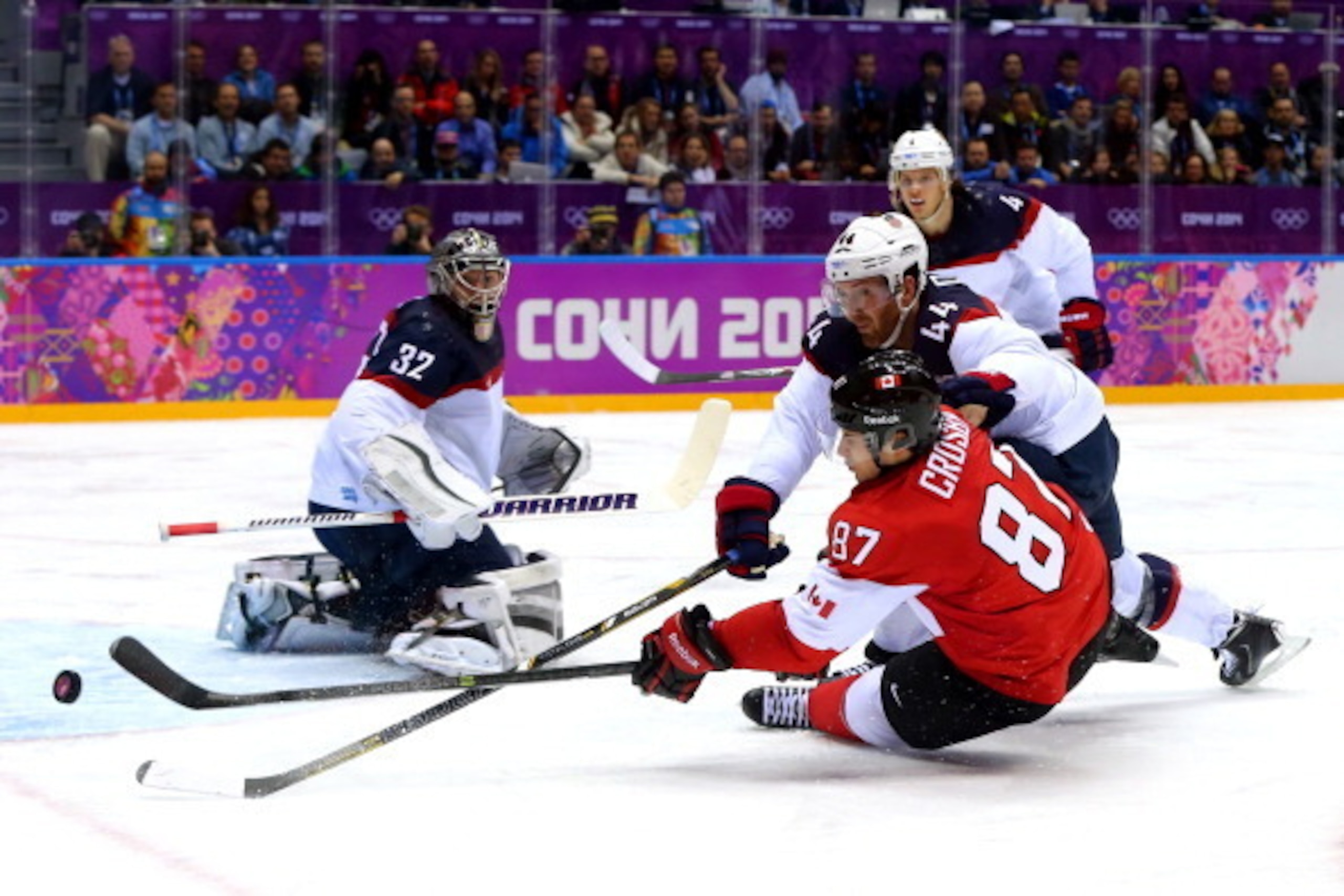 SOCHI, RUSSIA - FEBRUARY 21:  Sidney Crosby #87 of Canada attempts to score against Brooks Orpik #44 and Jonathan Quick #32 of the United States during the Men's Ice Hockey Semifinal Playoff on Day 14 of the 2014 Sochi Winter Olympics at Bolshoy Ice Dome