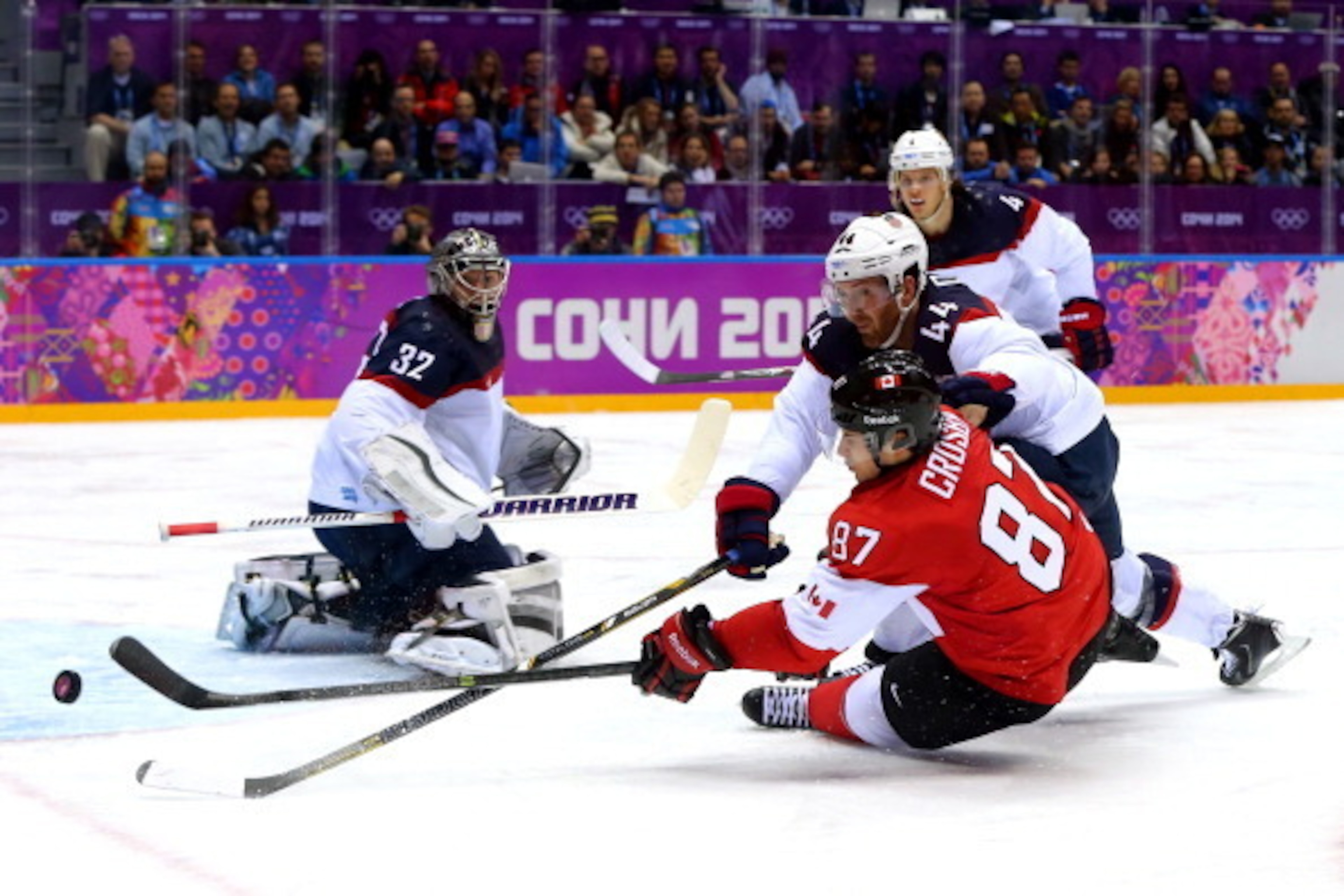 SOCHI, RUSSIA - FEBRUARY 21:  Sidney Crosby #87 of Canada attempts to score against Brooks Orpik #44 and Jonathan Quick #32 of the United States during the Men's Ice Hockey Semifinal Playoff on Day 14 of the 2014 Sochi Winter Olympics at Bolshoy Ice Dome
