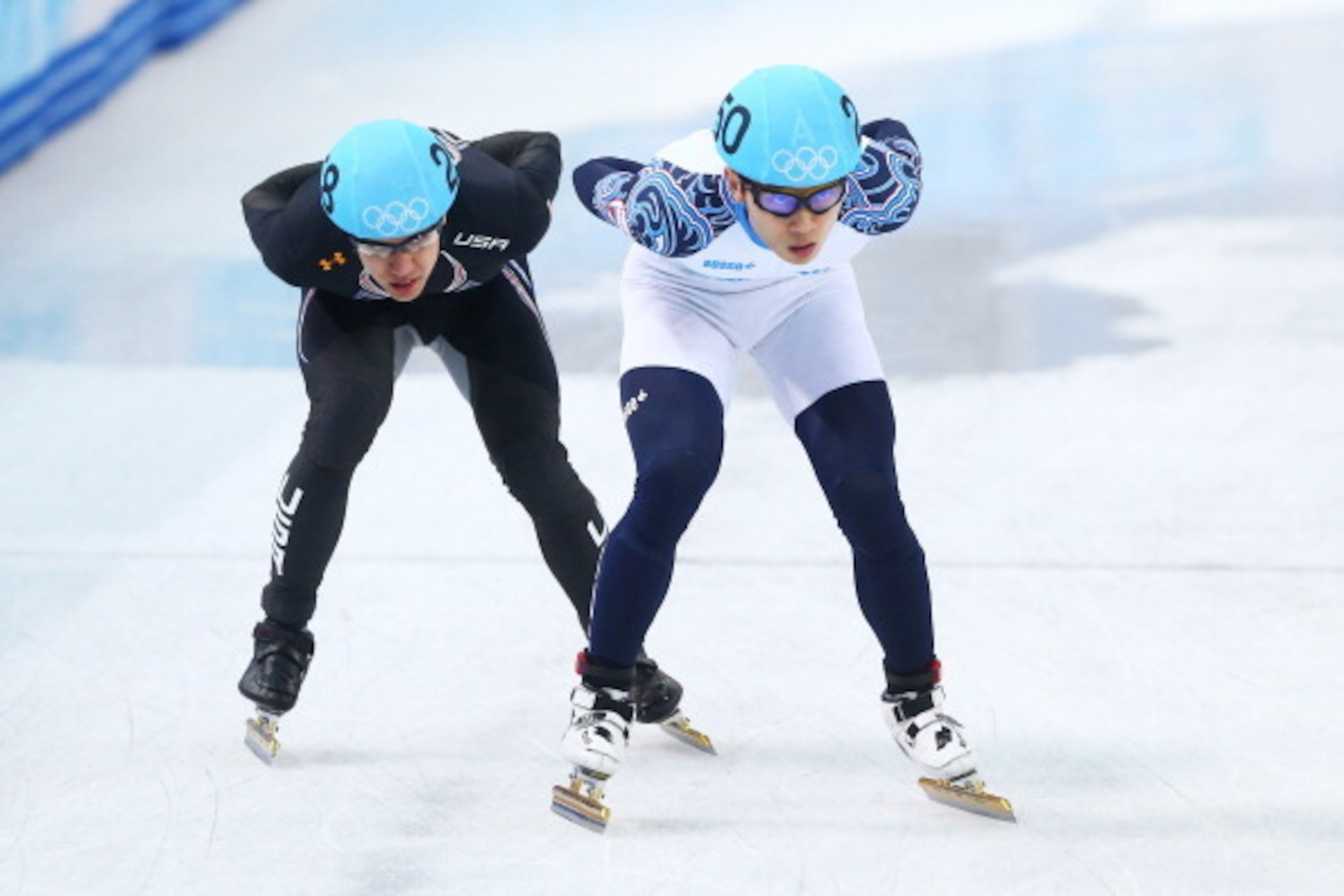 SOCHI, RUSSIA - FEBRUARY 21:  Victor An (R) of Russia and J.R. Celski of the United States compete in the Short Track Men's 5000m Relay A on day fourteen of the 2014 Sochi Winter Olympics at Iceberg Skating Palace on February 21, 2014 in Sochi, Russia.  (