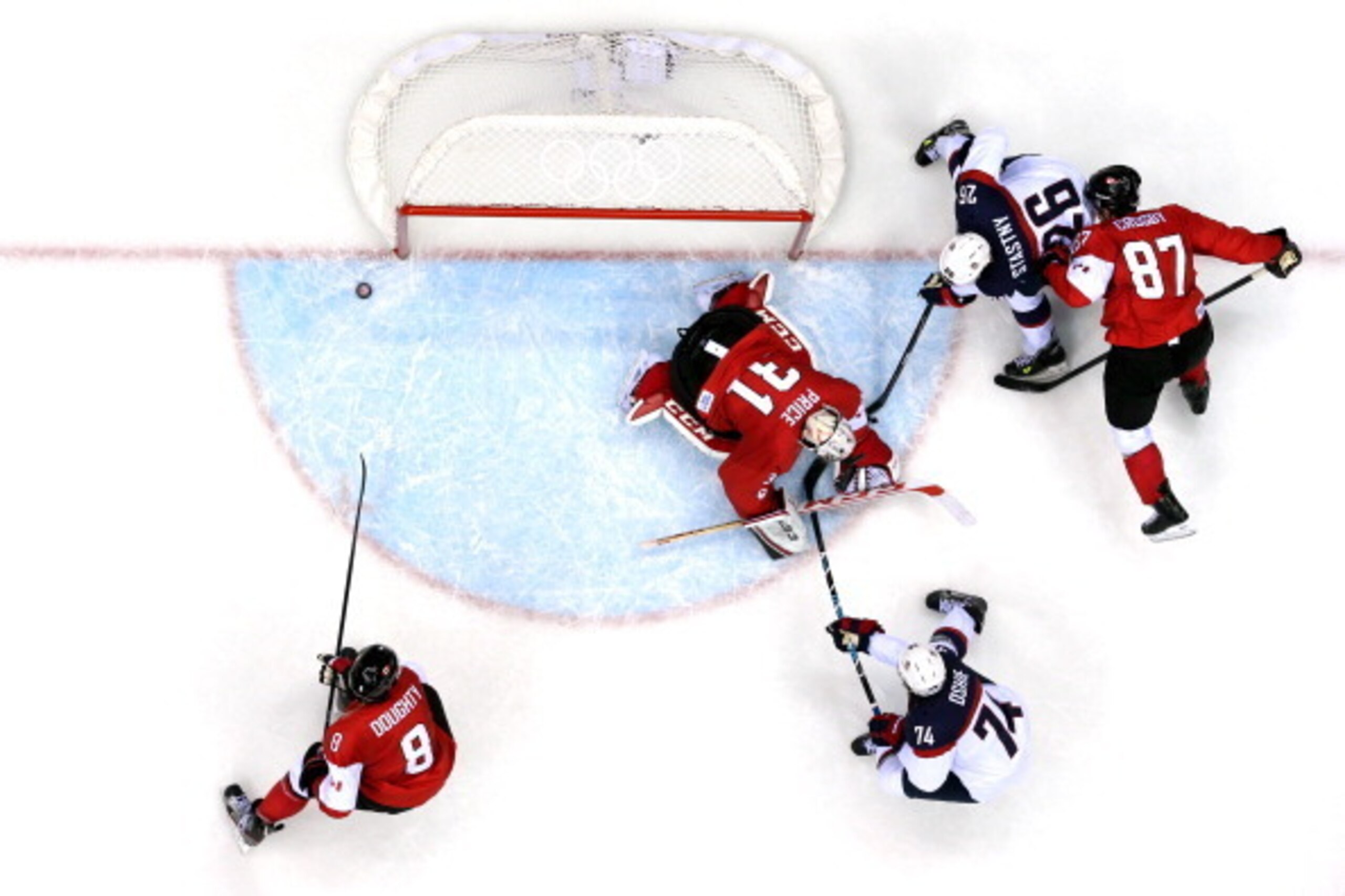 SOCHI, RUSSIA - FEBRUARY 21:  Carey Price #31 of Canada makes a save against T.J. Oshie #74 and Paul Stastny #26 of the United States during the Men's Ice Hockey Semifinal Playoff on Day 14 of the 2014 Sochi Winter Olympics at Bolshoy Ice Dome on February