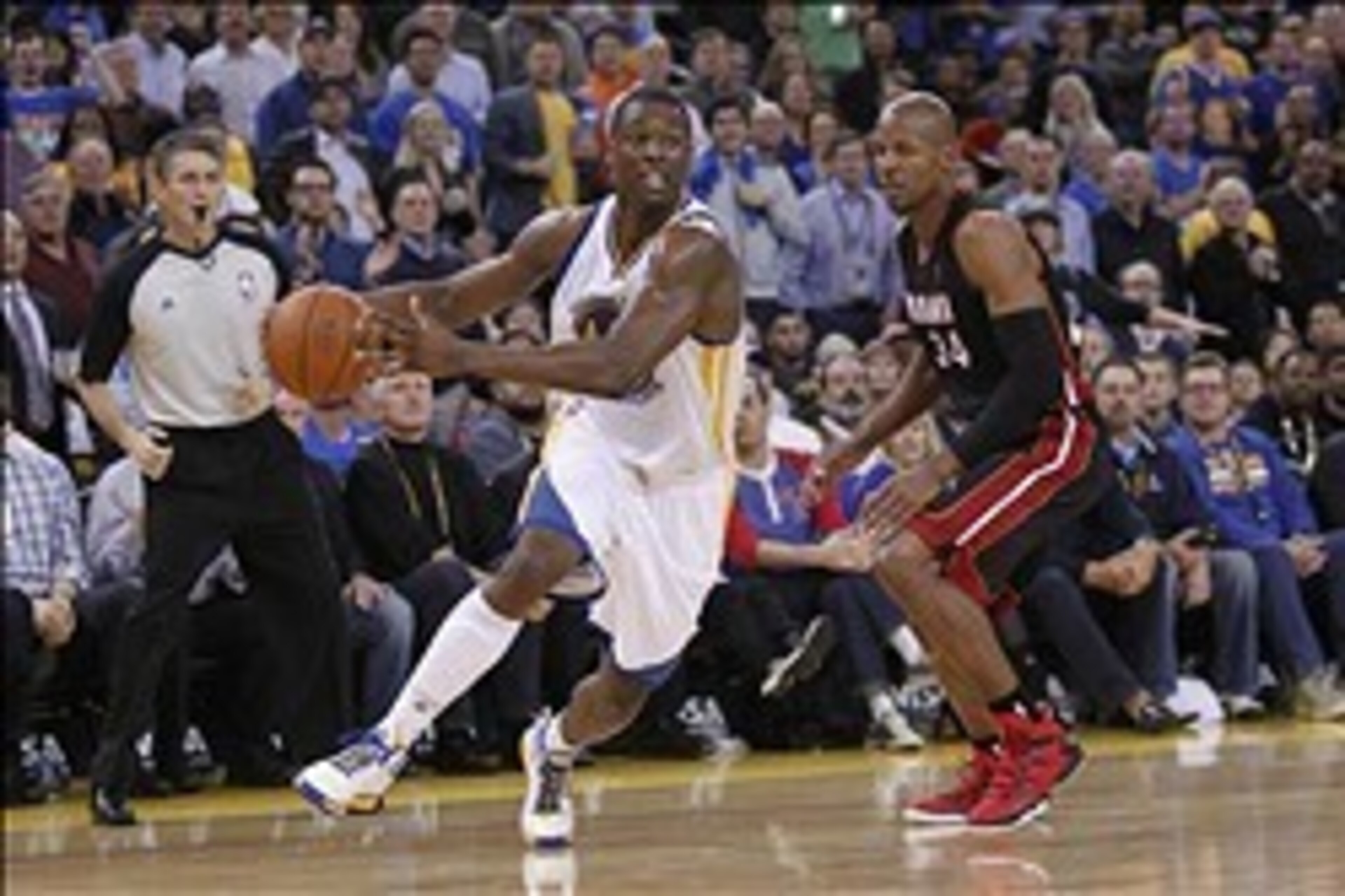 Feb 12, 2014; Oakland, CA, USA; Golden State Warriors forward Harrison Barnes (40) moves past Miami Heat guard Ray Allen (34) in the third quarter at Oracle Arena. The Heat defeated the Warriors 111-110. Mandatory Credit: Cary Edmondson-USA TODAY Sports