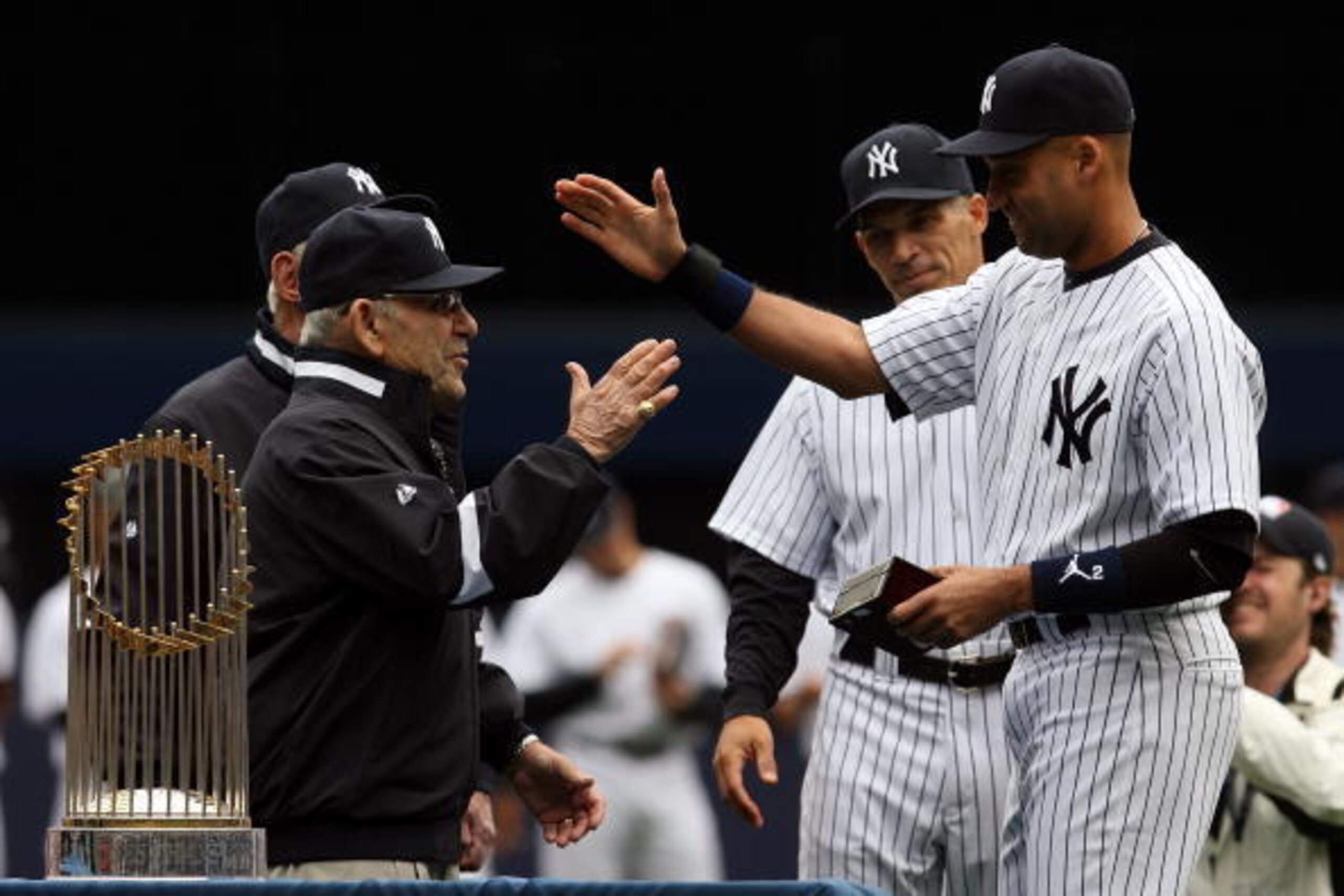 NEW YORK - APRIL 13:  Yankee legend and Baseball Hall of Famer Yogi Berra presents Derek Jeter #2 of the New York Yankees with his World Series ring for the 2009 season prior to playing against the Los Angeles Angels of Anaheim during the Yankees home ope