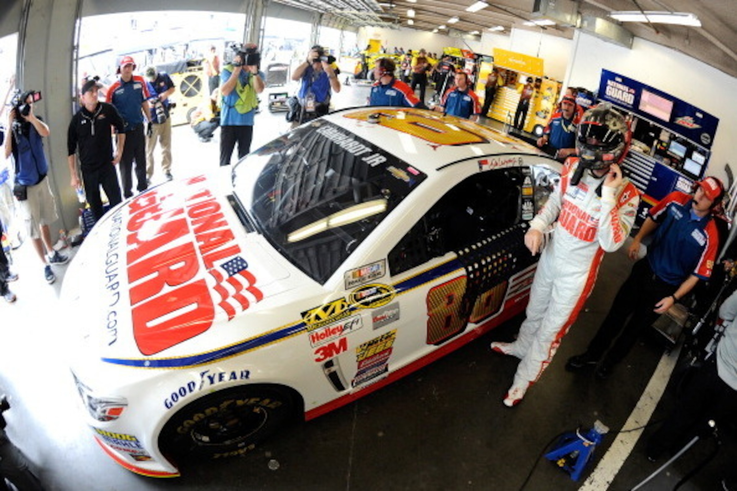 DAYTONA BEACH, FL - FEBRUARY 21: Dale Earnhardt Jr., driver of the #88 National Guard Chevrolet, stands in the garage during practice for the NASCAR Sprint Cup Series Daytona 500 at Daytona International Speedway on February 21, 2014 in Daytona Beach, Flo