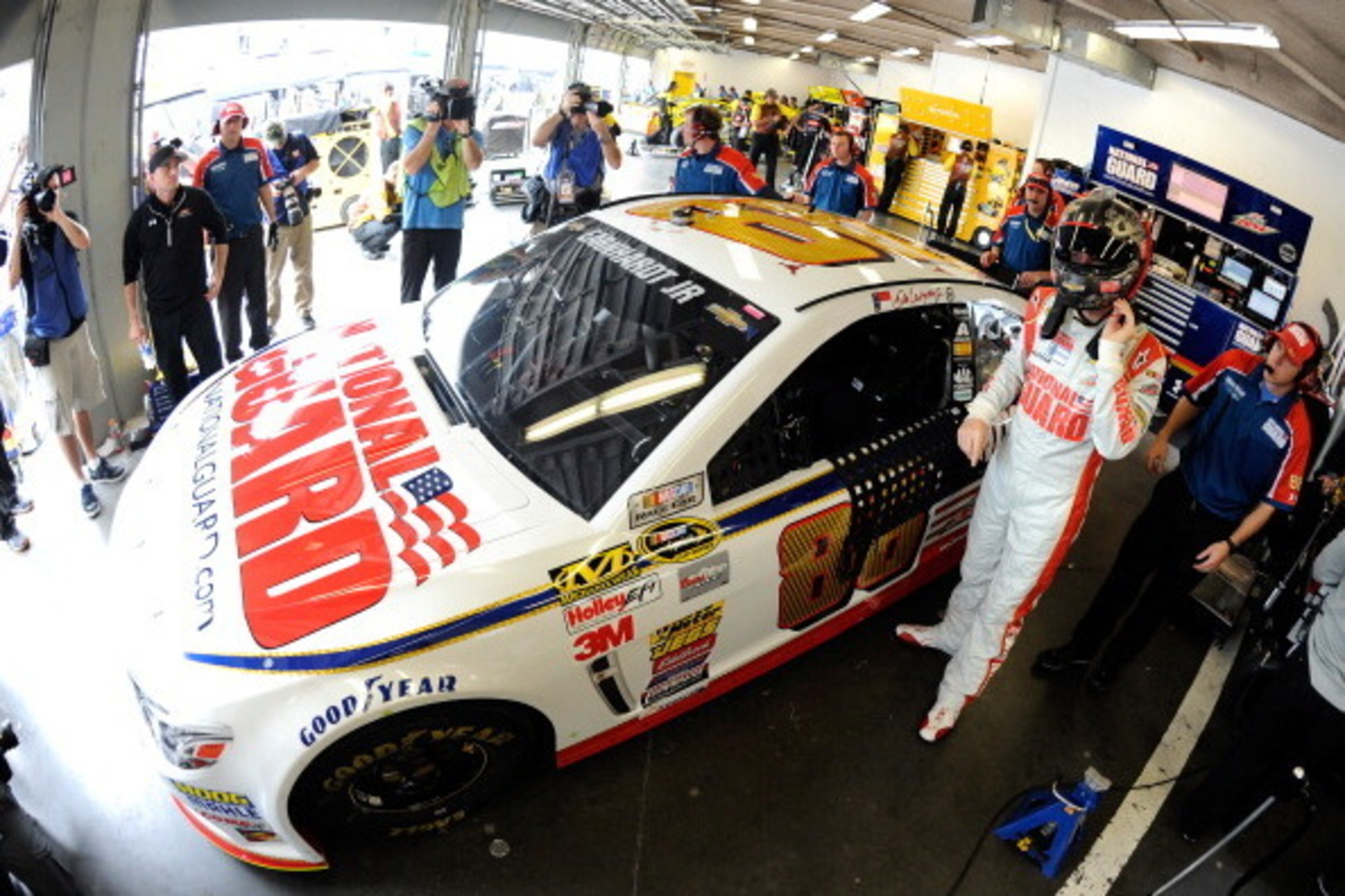 DAYTONA BEACH, FL - FEBRUARY 21: Dale Earnhardt Jr., driver of the #88 National Guard Chevrolet, stands in the garage during practice for the NASCAR Sprint Cup Series Daytona 500 at Daytona International Speedway on February 21, 2014 in Daytona Beach, Flo