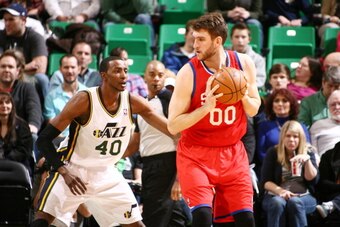 SALT LAKE CITY, UT - FEBRUARY 12:  Spencer Hawes #00 of the Philadelphia 76ers drives against Jeremy Evans #40 of the Utah Jazz at EnergySolutions Arena on February 12, 2014 in Salt Lake City, Utah. NOTE TO USER: User expressly acknowledges and agrees tha