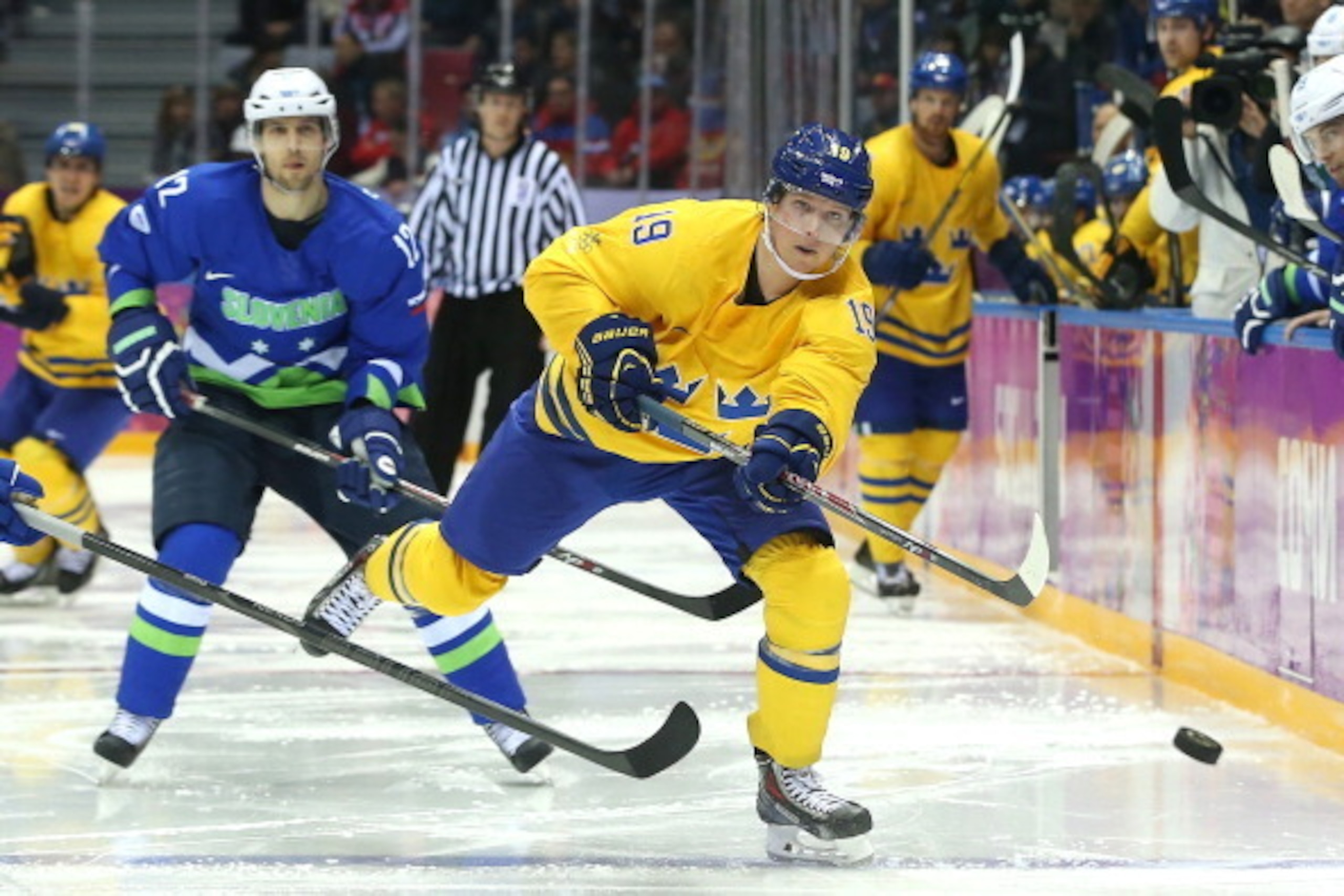 SOCHI, RUSSIA - FEBRUARY 19: Nicklas Backstrom #19 of Sweden fires the puck against David Rodman #12 of Slovenia in the third period during the Men's Ice Hockey Quarterfinal Playoff on Day 12 of the 2014 Sochi Winter Olympics at Bolshoy Ice Dome on Februa