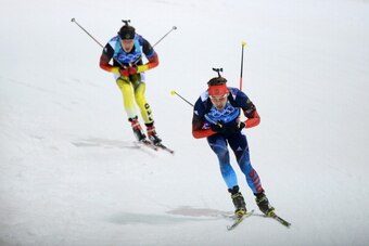 SOCHI, RUSSIA - FEBRUARY 22:  Anton Shipulin of Russia leads Simon Schempp of Germany during the Men's 4 x 7.5 km Relay during day 15 of the Sochi 2014 Winter Olympics at Laura Cross-country Ski & Biathlon Center on February 22, 2014 in Sochi, Russia.  (P