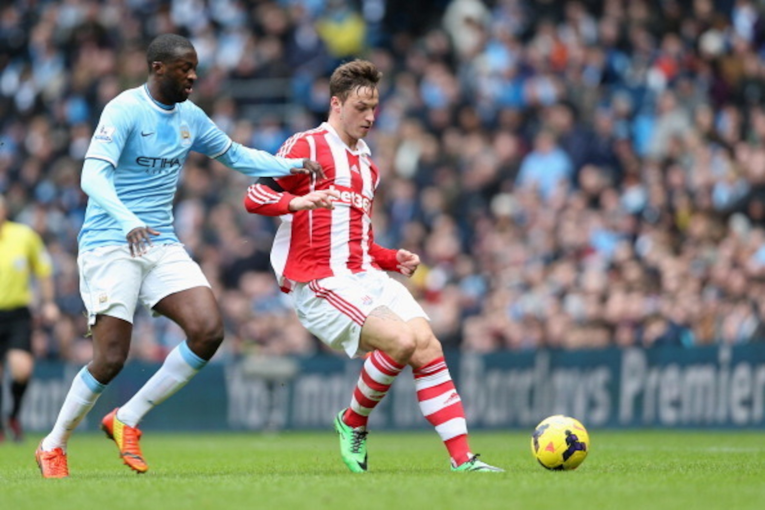 MANCHESTER, ENGLAND - FEBRUARY 22:  Marko Arnautovic of Stoke City in action with Yaya Toure of Manchester City during the Barclays Premier League match between Manchester City and Stoke City at the Etihad Stadium on February 22, 2014 in Manchester, Engla