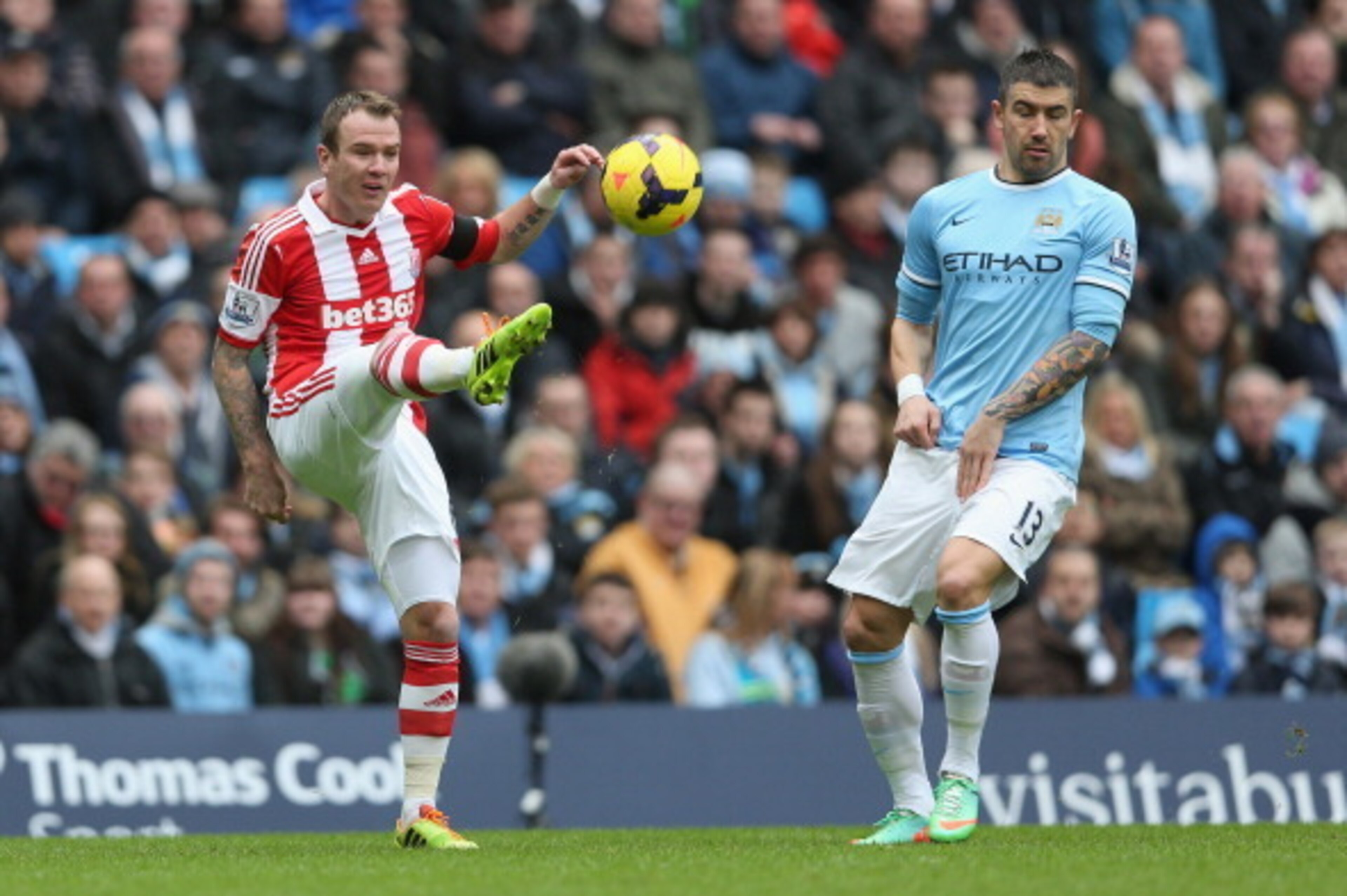 MANCHESTER, ENGLAND - FEBRUARY 22: Glenn Whelan of Stoke City shoots past Aleksandar Kolarov of Manchester City during the Barclays Premier League match between Manchester City and Stoke City at the Etihad Stadium on February 22, 2014 in Manchester, Engla