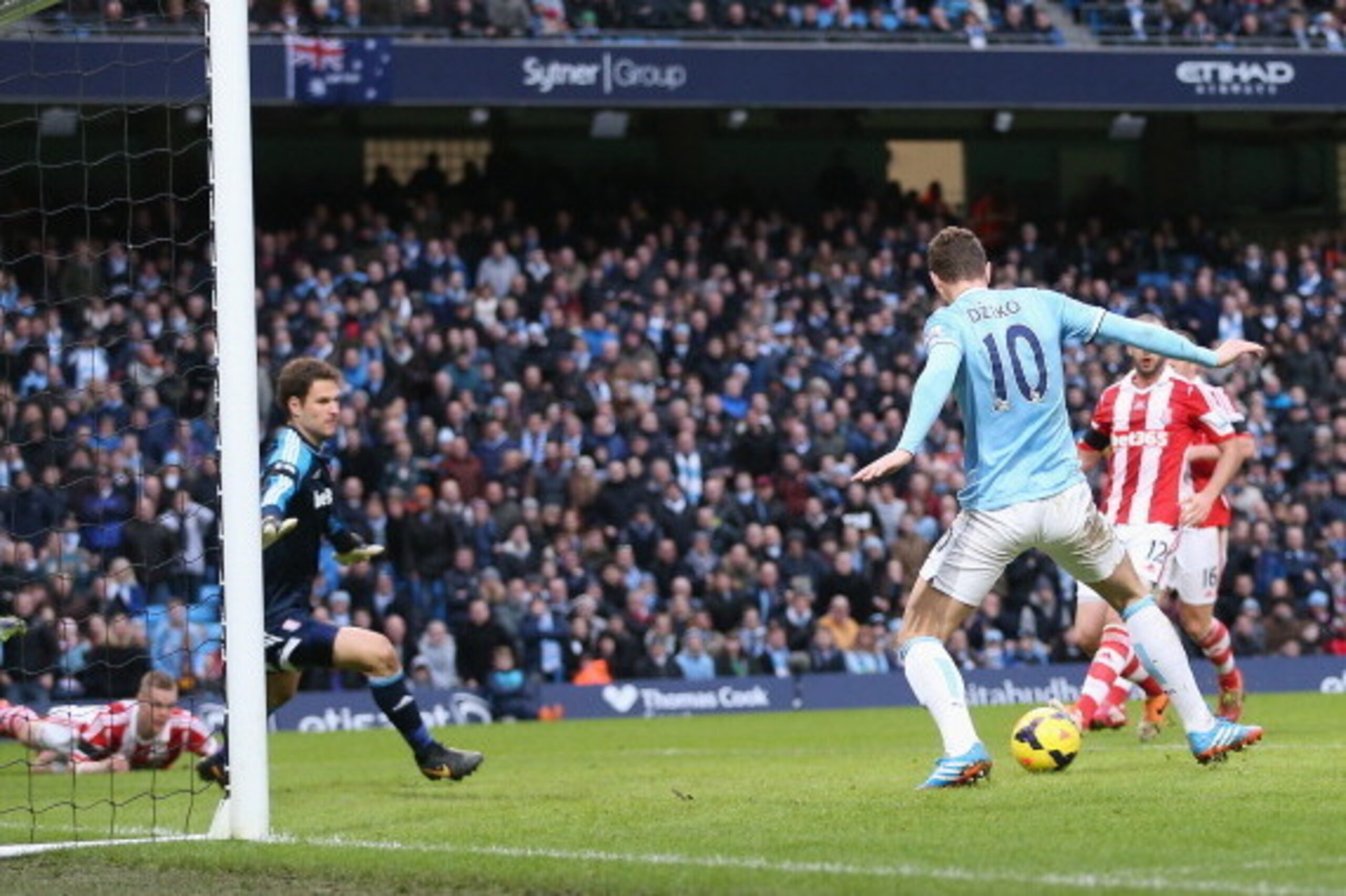 MANCHESTER, ENGLAND - FEBRUARY 22:  Edin Dzeko of Manchester City misses a close range shot on goal as Stoke City keeper Asmir Begovic looks on  during the Barclays Premier League match between Manchester City and Stoke City at the Etihad Stadium on Febru