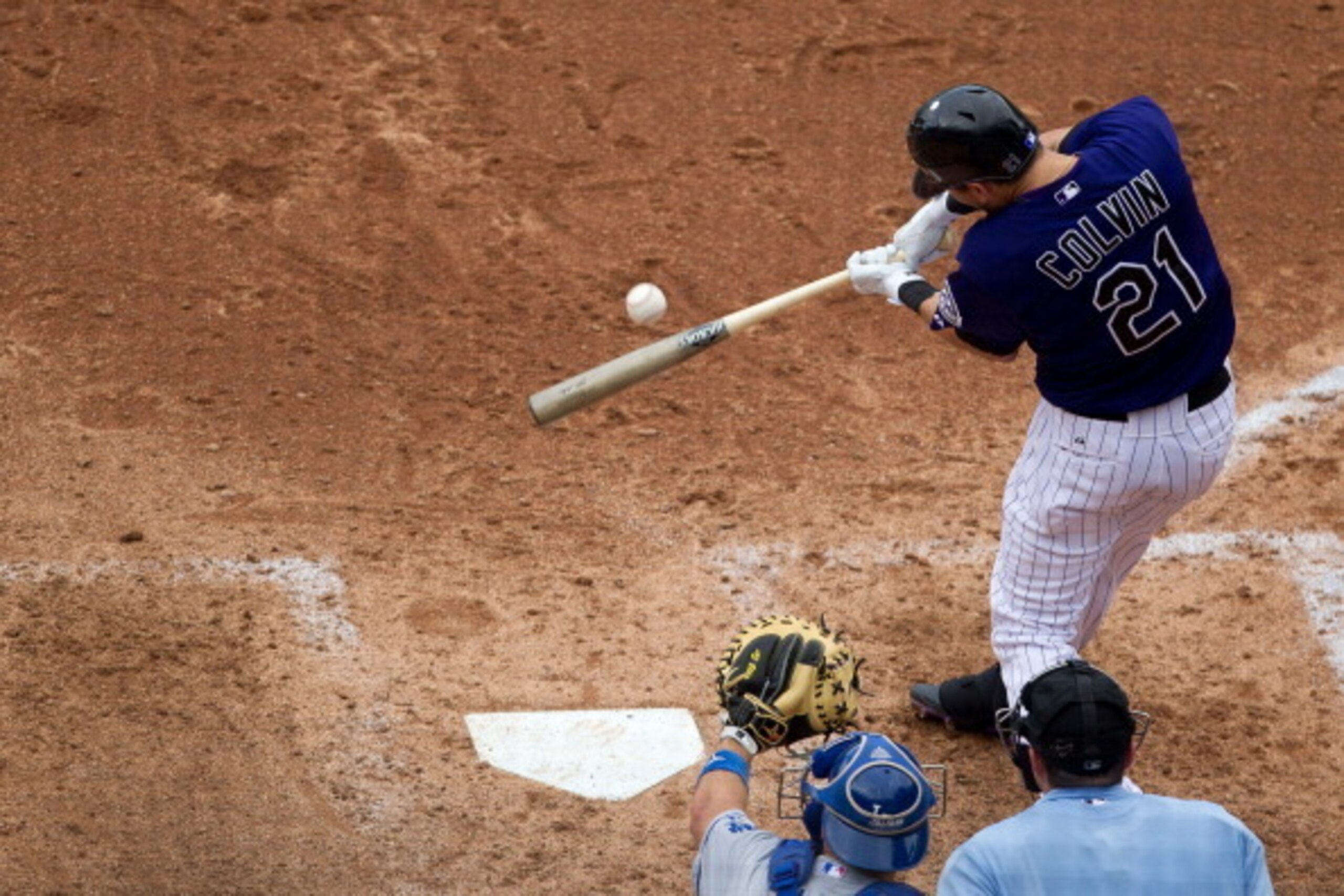 DENVER, CO - AUGUST 29:  Tyler Colvin #21 of the Colorado Rockies hits an RBI single during the seventh inning against the Los Angeles Dodgers at Coors Field on August 29, 2012 in Denver, Colorado.  The Dodgers defeated the Rockies 10-8 to avoid the three