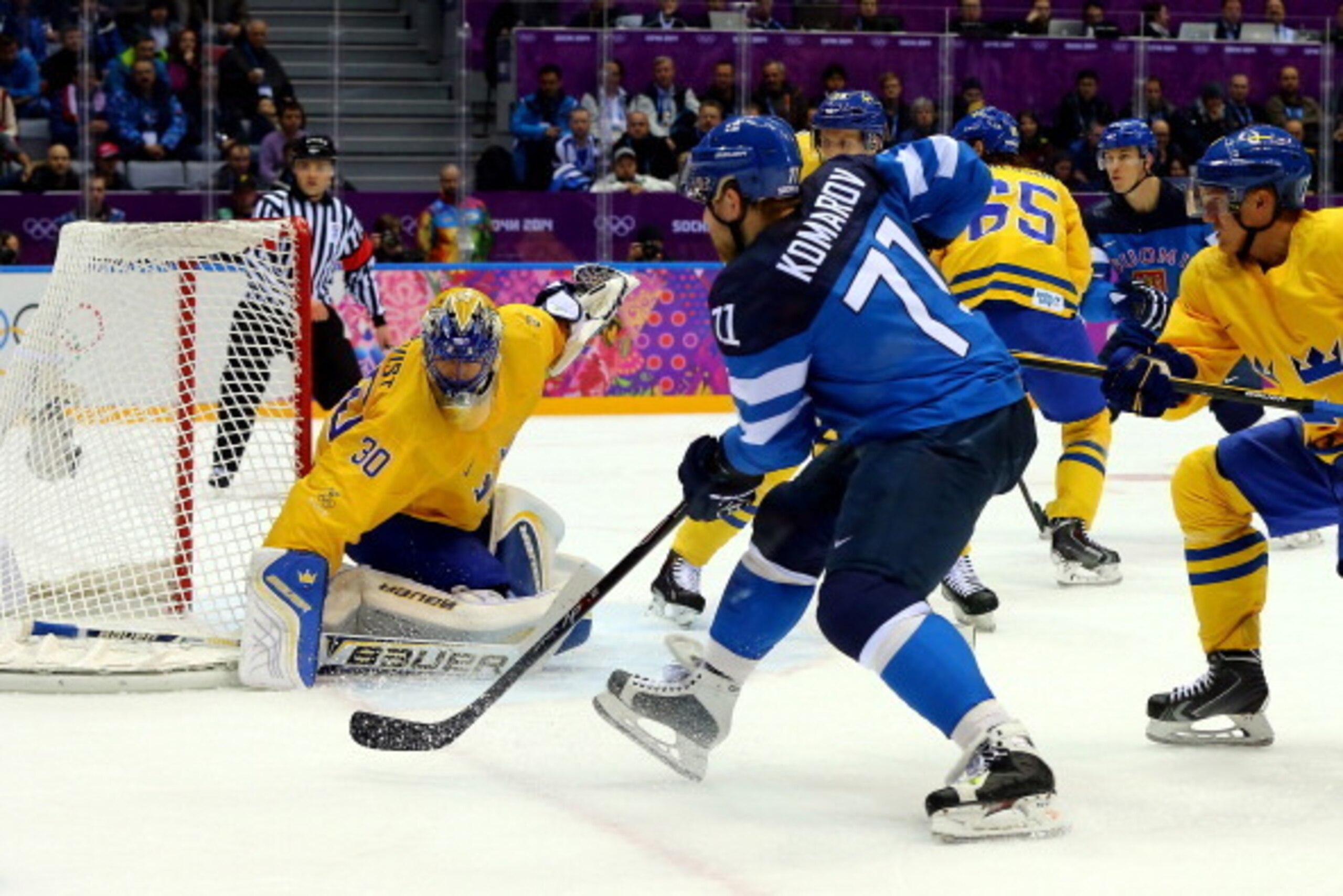 SOCHI, RUSSIA - FEBRUARY 21:  Leo Komarov #71 of Finland brings the puck to the net against Henrik Lundqvist #30 of Sweden during the Men's Ice Hockey Semifinal Playoff on Day 14 of the 2014 Sochi Winter Olympics at Bolshoy Ice Dome on February 21, 2014 i