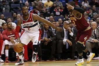 Feb 7, 2014; Washington, DC, USA; Washington Wizards guard John Wall (2) dribbles the ball as Cleveland Cavaliers guard Kyrie Irving (2) defends in the second quarter at Verizon Center. Mandatory Credit: Geoff Burke-USA TODAY Sports