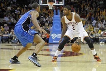 Feb 19, 2014; Cleveland, OH, USA; Cleveland Cavaliers point guard Kyrie Irving (2) dribbles against Orlando Magic shooting guard Arron Afflalo (4) in the third quarter at Quicken Loans Arena. Mandatory Credit: David Richard-USA TODAY Sports