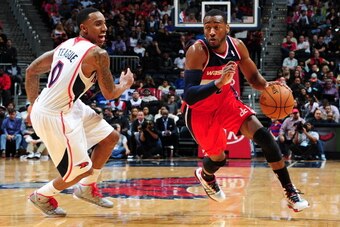 ATLANTA, GA - FEBRUARY 19: John Wall #2 of the Washington Wizards drives against the Atlanta Hawks on February 19, 2014 at Philips Arena in Atlanta, Georgia.  NOTE TO USER: User expressly acknowledges and agrees that, by downloading and/or using this Phot