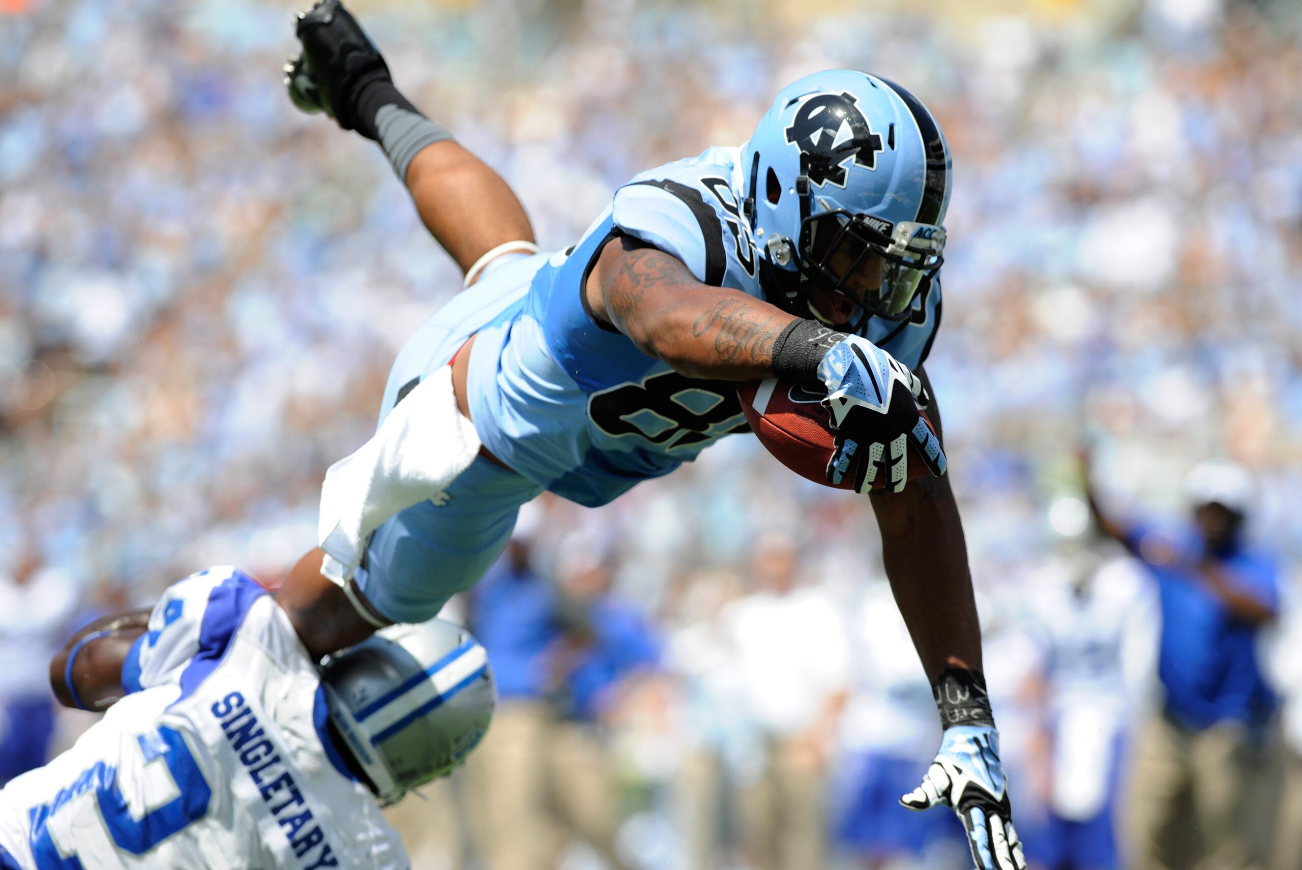 Sep 7, 2013; Chapel Hill, NC, USA;  North Carolina Tar Heels tight end Eric Ebron (85) dives into the endzone over Middle Tennessee Blue Raiders corner back Jared Singletary (24) on a 2-point conversion attempt at Kenan Memorial Stadium. Mandatory Credit: