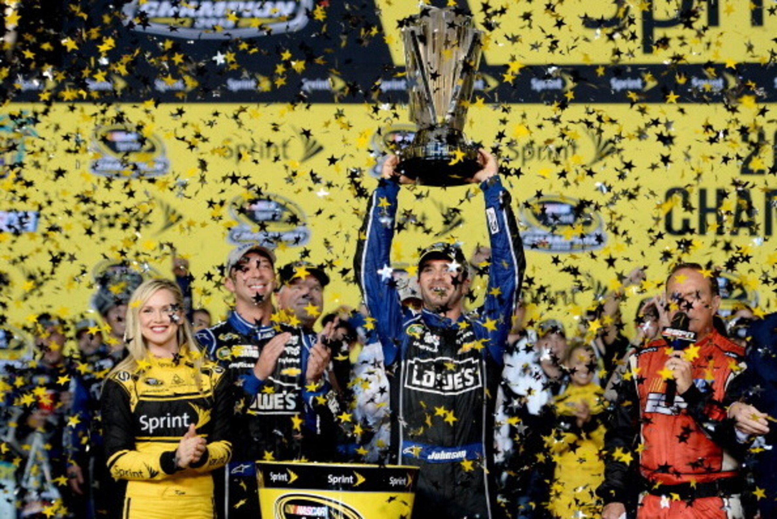 HOMESTEAD, FL - NOVEMBER 17:  Jimmie Johnson, driver of the #48 Lowe's/Kobalt Tools Chevrolet, celebrates with champagne in Champions Victory Lane after winning the series championship following the NASCAR Sprint Cup Series Ford EcoBoost 400 at Homestead-