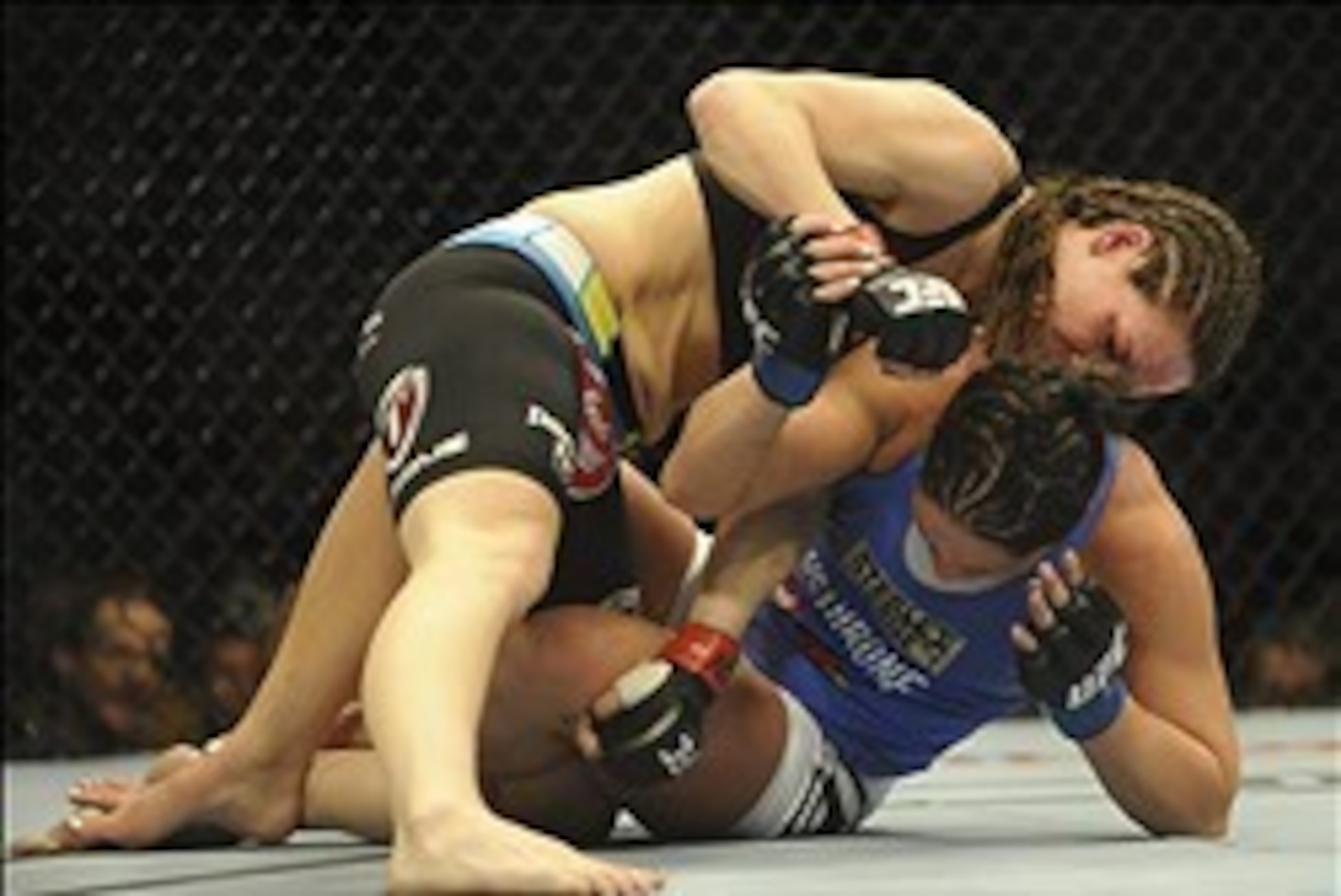 Feb 22, 2014; Las Vegas, NV, USA; Jessica Eye (blue gloves) fights to get out from under Alexis Davis (red gloves) during their UFC bantamweight bout at Mandalay Bay. Davis won by split decision.  Mandatory Credit: Stephen R. Sylvanie-USA TODAY Sports