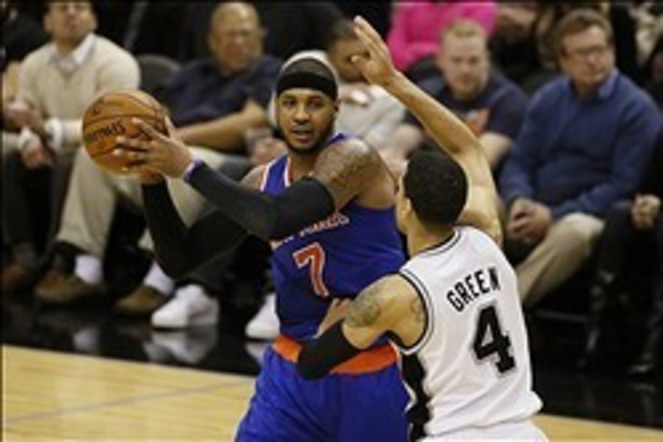 Jan 2, 2014; San Antonio, TX, USA; New York Knicks forward Carmelo Anthony (7) is defended by San Antonio Spurs guard Danny Green (4) during the second half at AT&T Center. The Knicks won 105-101. Mandatory Credit: Soobum Im-USA TODAY Sports