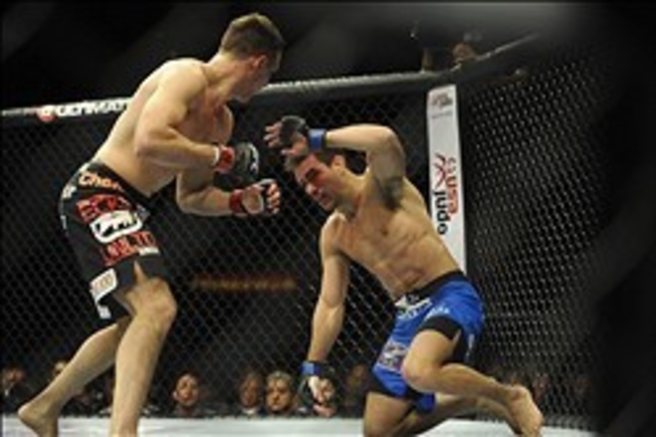 Feb 22, 2014; Las Vegas, NV, USA; Demian Maia (blue gloves) throws up his arm to block hits by Rory MacDonald (red gloves) during their UFC welterweight bout at Mandalay Bay. MacDonald won by way of a 29-28 decision. Mandatory Credit: Stephen R. Sylvanie-