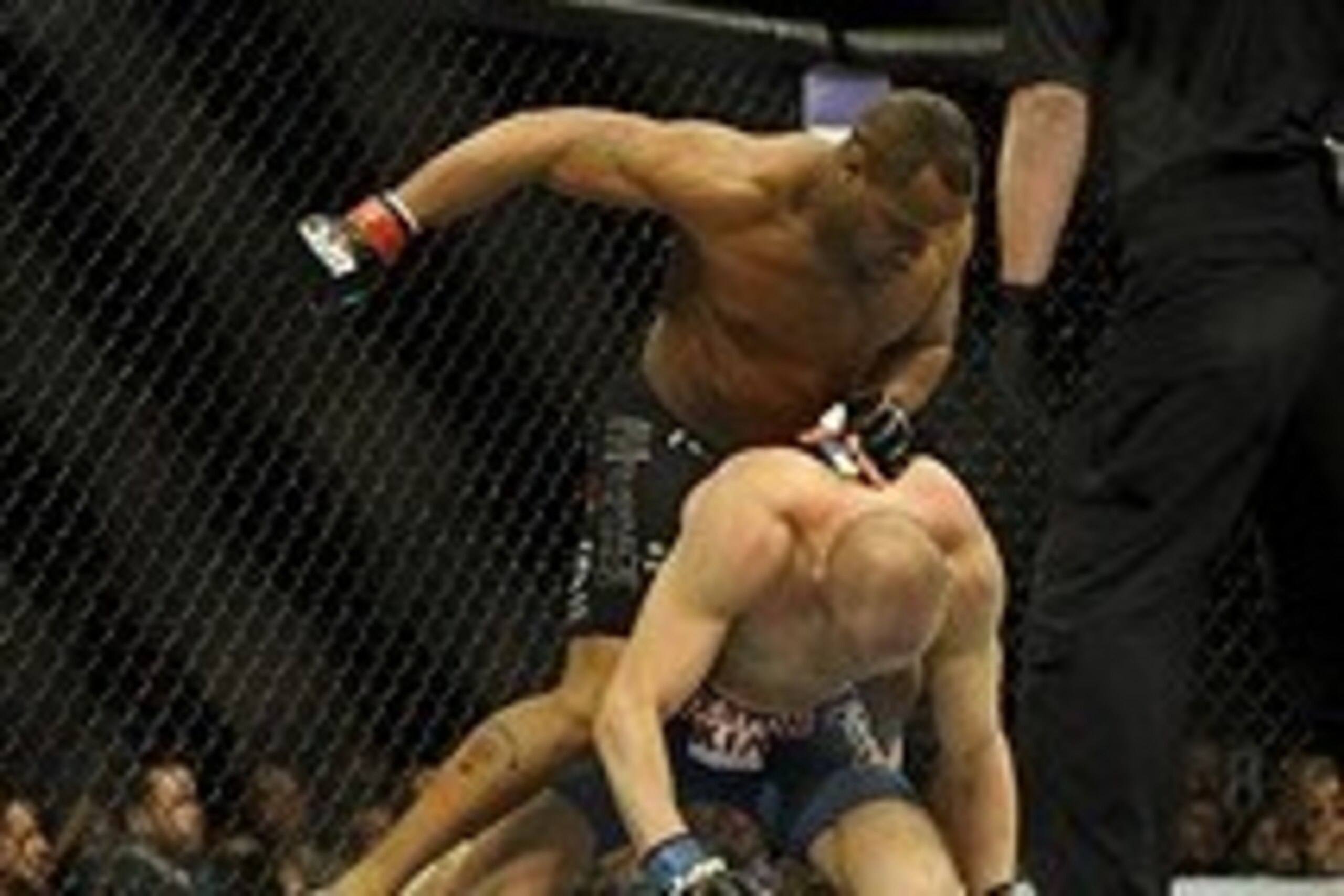 Feb 22, 2014; Las Vegas, NV, USA;  Daniel Cormier (red gloves) tries to land a punch from above on Patrick Cummins (blue gloves) during their UFC light heavyweight bout at Mandalay Bay. Cormier won by way of a TKO in the first round. Mandatory Credit: Ste