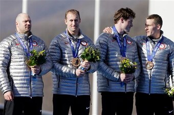 Holcomb and his teammates receiving their bronze medals.