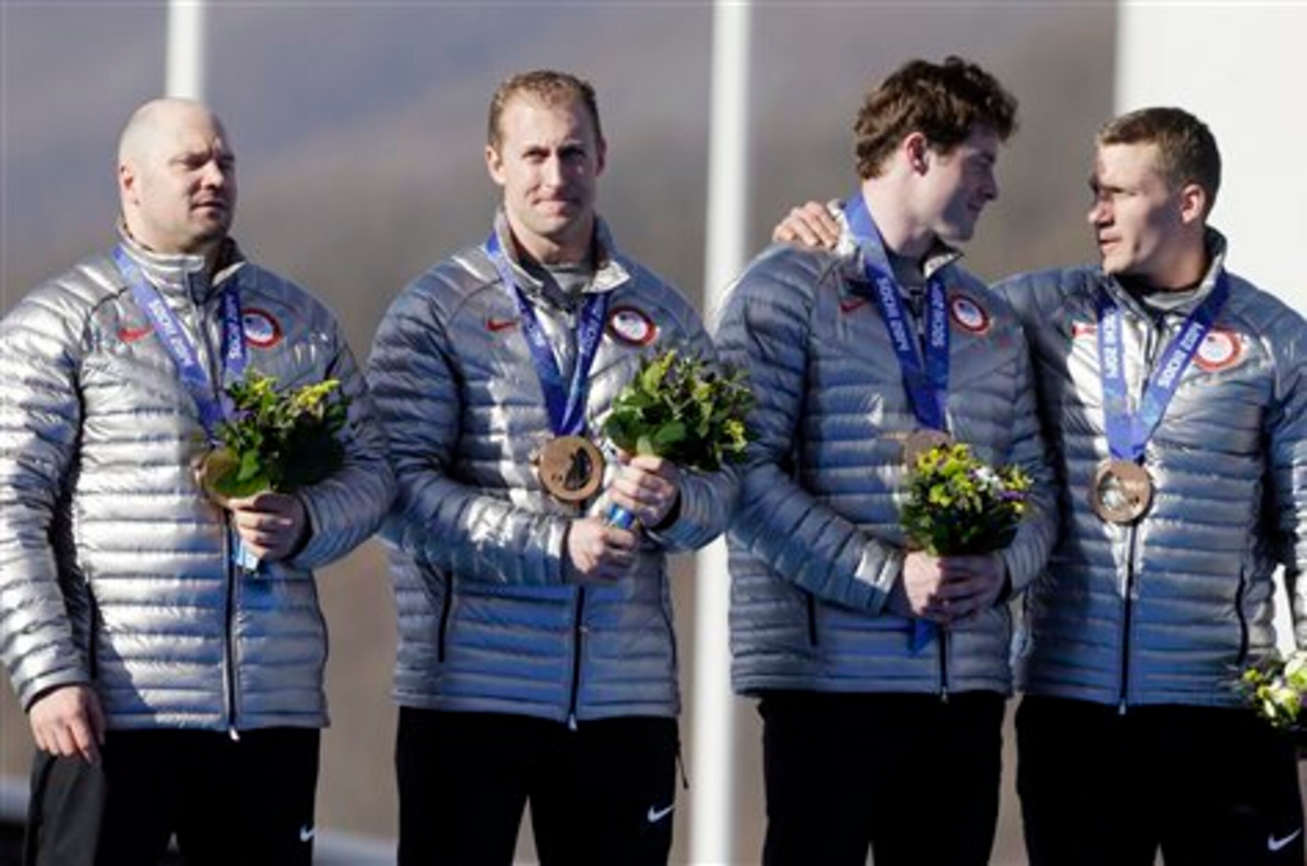 Holcomb and his teammates receiving their bronze medals.