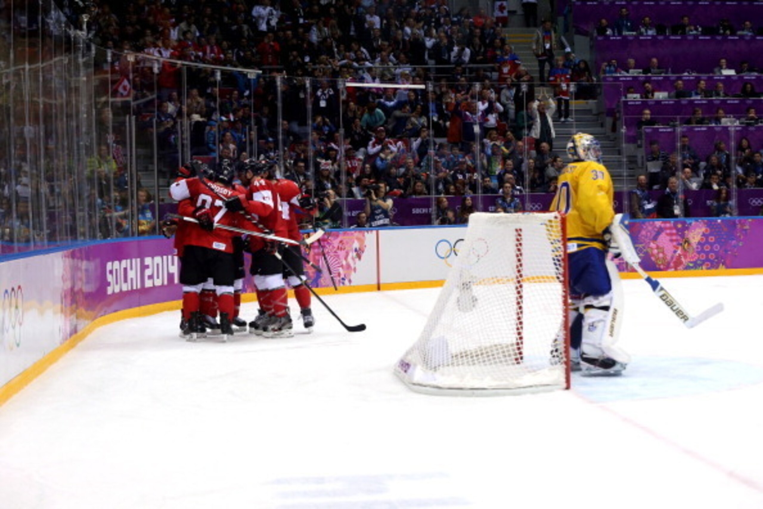 SOCHI, RUSSIA - FEBRUARY 23:  Chris Kunitz #14 of Canada celebrates with teammates Drew Doughty #8, Marc-Edouard Vlasic #44 and Sidney Crosby #87 after scoring a third-period goal against Henrik Lundqvist #30 of Sweden during the Men's Ice Hockey Gold Med