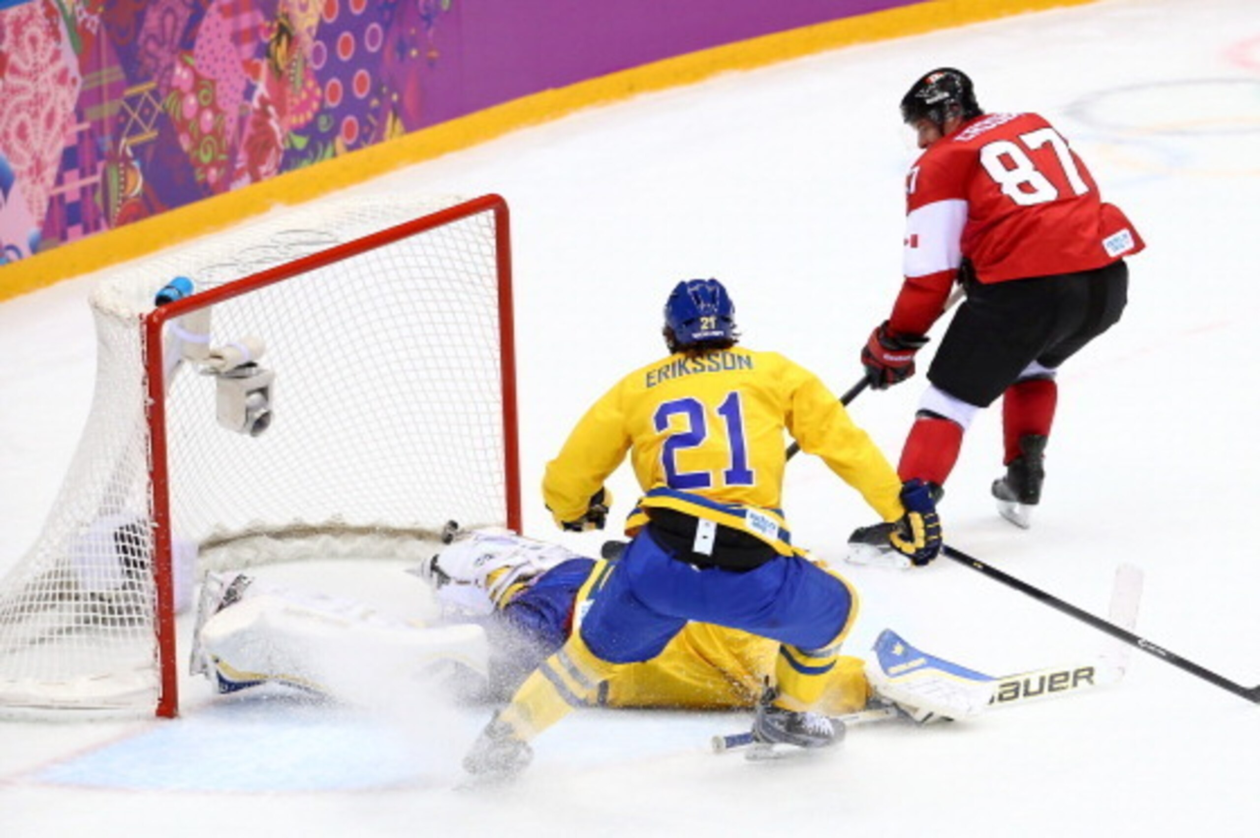 SOCHI, RUSSIA - FEBRUARY 23:  Sidney Crosby #87 of Canada scores a goal against Henrik Lundqvist #30 of Sweden as Loui Eriksson #21 of Sweden looks on during the Men's Ice Hockey Gold Medal match on Day 16 of the 2014 Sochi Winter Olympics at Bolshoy Ice 