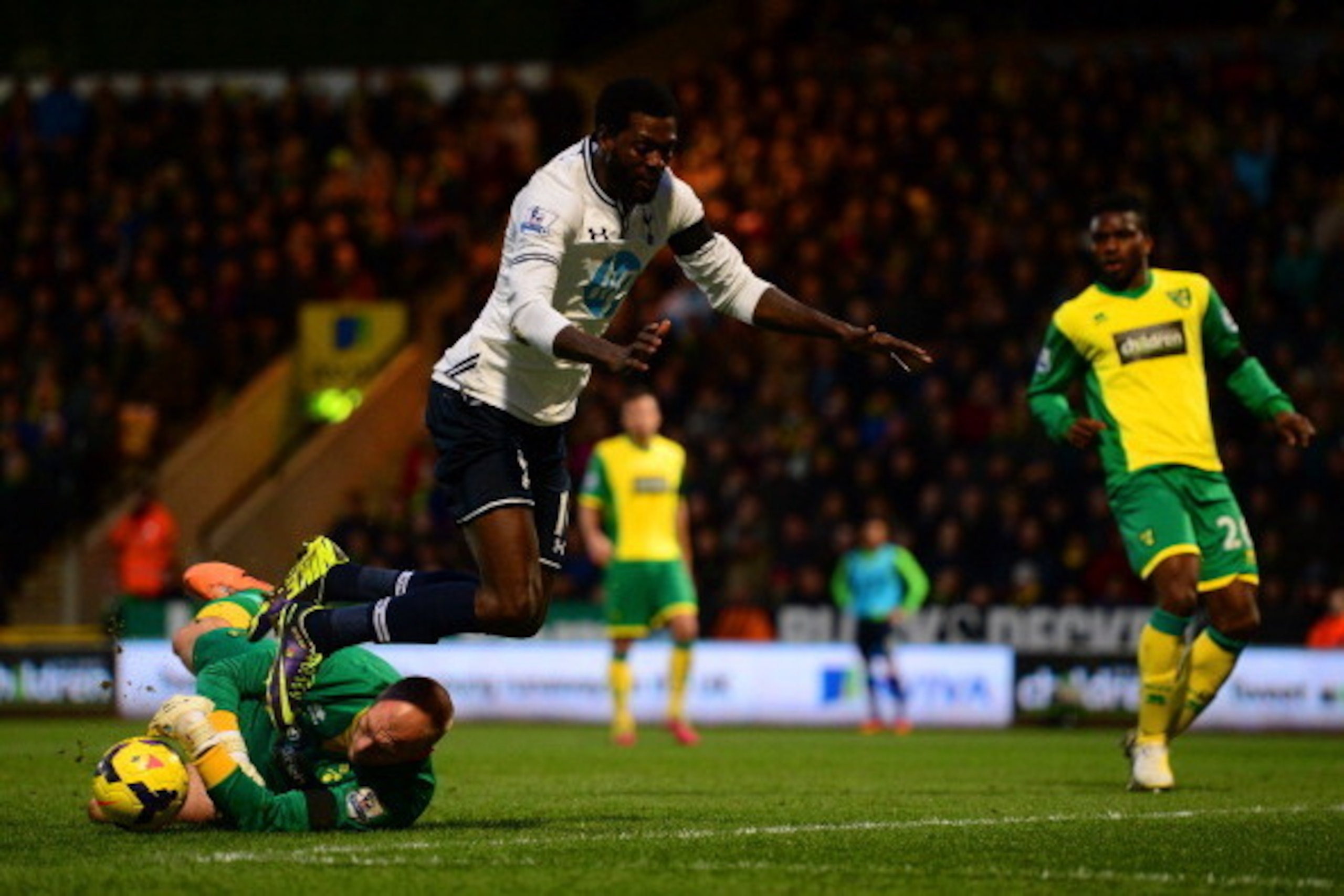 NORWICH, ENGLAND - FEBRUARY 23: John Ruddy of Norwich City clashes with Emmanuel Adebayor of Tottenham Hotspur during the Barclays Premier League match between Norwich City and Tottenham Hotspur at Carrow Road on February 23, 2014 in Norwich, England. (P NORWICH, ENGLAND - FEBRUARY 23: John Ruddy of Norwich City clashes with Emmanuel Adebayor of Tottenham Hotspur during the Barclays Premier League match between Norwich City and Tottenham Hotspur at Carrow Road on February 23, 2014 in Norwich, England. (P