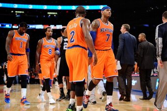 NEW YORK, NY - NOVEMBER 10:  Carmelo Anthony #7 of the New York Knicks walks into the locker room during half time against the San Antonio Spurs with his teammates Raymond Felton #2, J.R. Smith #8 and Amar'e Stoudemire #1 at Madison Square Garden on Novem