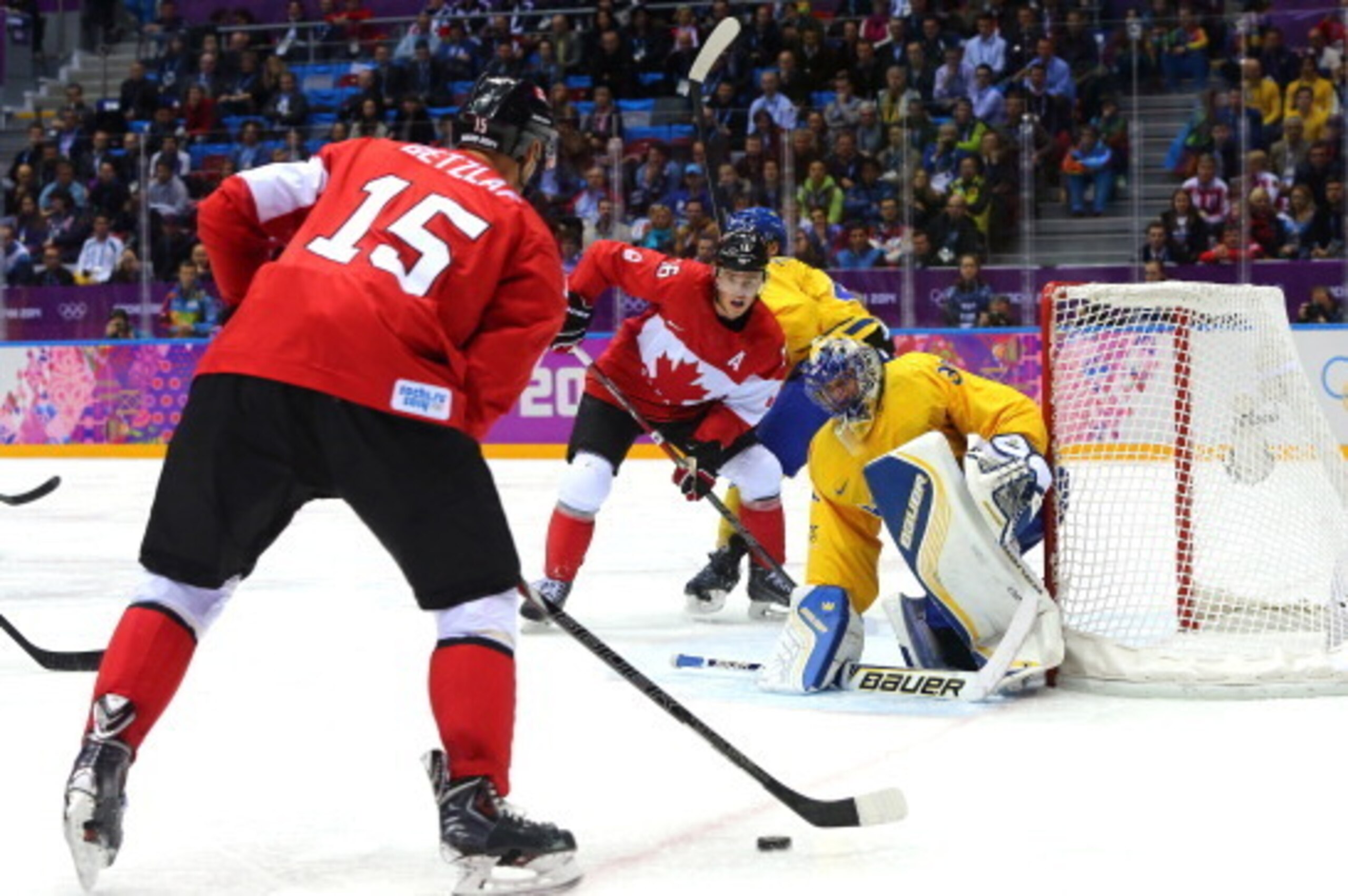 SOCHI, RUSSIA - FEBRUARY 23:  Ryan Getzlaf #15 of Canada attacks the goal tended by Henrik Lundqvist #30 of Sweden during the Men's Ice Hockey Gold Medal match on Day 16 of the 2014 Sochi Winter Olympics at Bolshoy Ice Dome on February 23, 2014 in Sochi, 