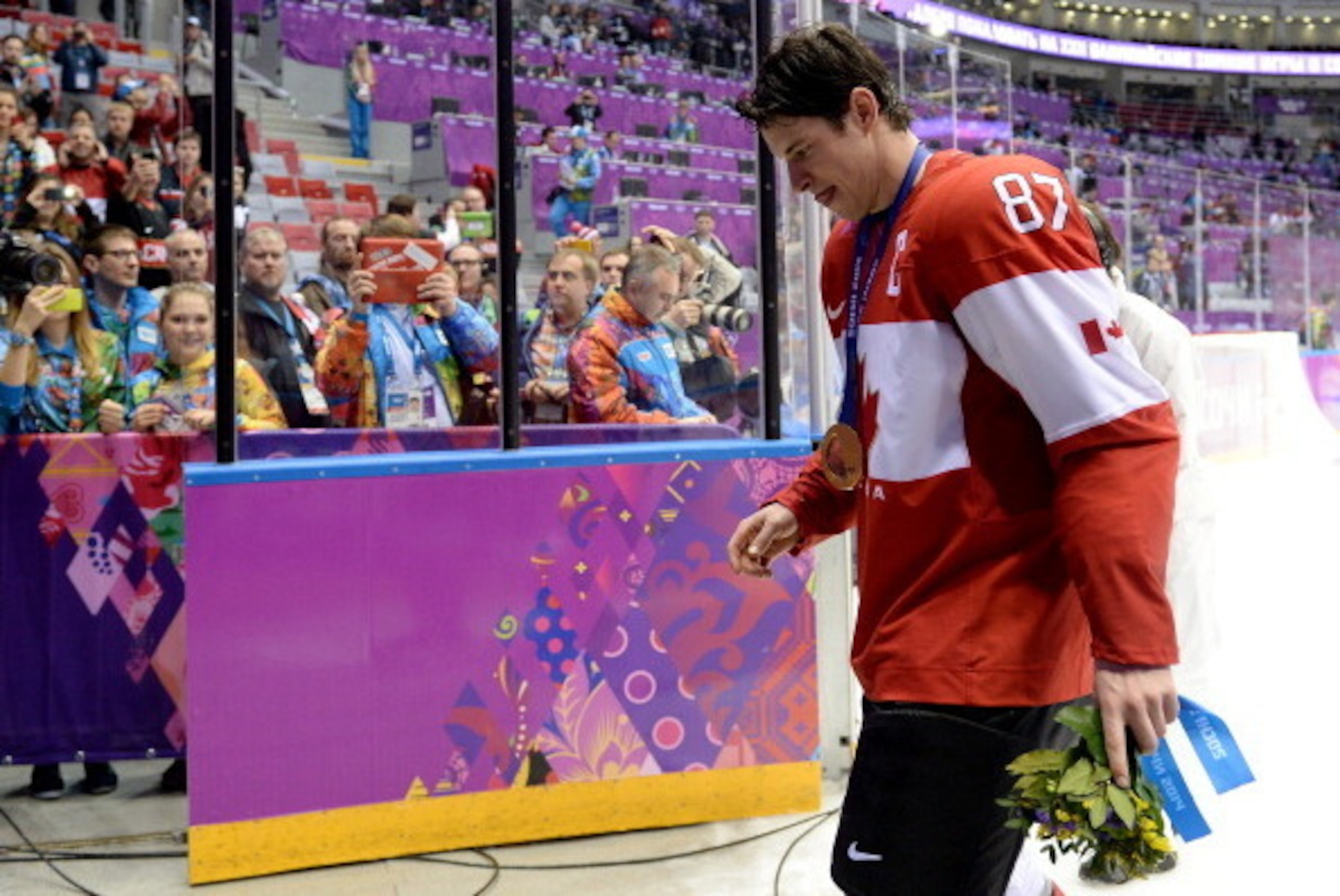 SOCHI, RUSSIA - FEBRUARY 23:  Sidney Crosby #87 of Canada leaves the ice with his gold medal following his team's 3-0 victory during the Men's Ice Hockey Gold Medal match against Sweden on Day 16 of the 2014 Sochi Winter Olympics at Bolshoy Ice Dome on Fe