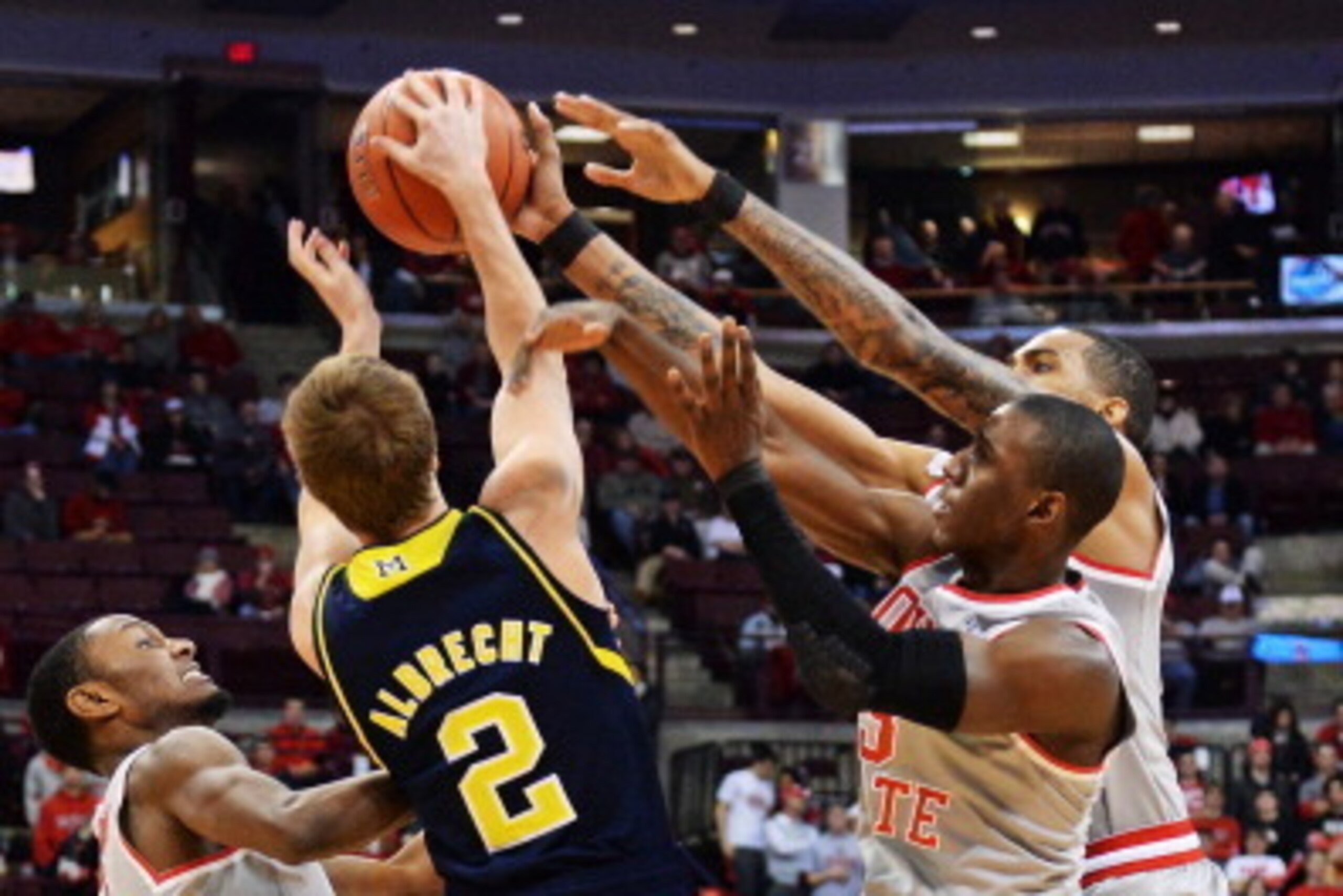 COLUMBUS, OH - FEBRUARY 11:  Ohio State Buckeyes Sam Thompson #12, Shannon Scott #3 and LaQuinton Ross #10 converge to force Spike Albrecht #2 of the Michigan Wolverines to turn over the ball in the second half on February 11, 2014 at Value City Arena in 