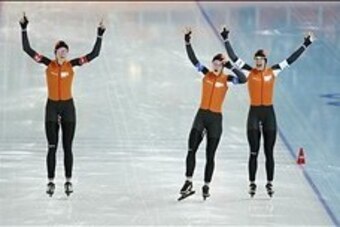 Feb 22, 2014; Sochi, RUSSIA;  Jorien Ter Mors, left, Ireen Wust, middle and Marrit Leenstra of Netherlands celebrate their gold medal in Olympic record time in speed skating ladies' team pursuit during the Sochi 2014 Olympic Winter Games at Adler Arena Sk
