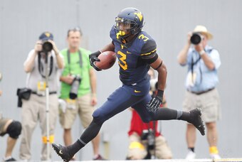 Aug 31, 2013; Morgantown, WV, USA; West Virginia Mountaineers running back Charles Sims (3) carries the ball into the end zone for a touchdown against the William & Mary Tribe during the first quarter at Milan Puskar Stadium. Mandatory Credit: Charles LeC