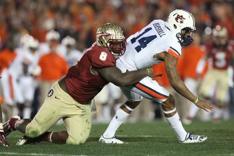 Jan 6, 2014; Pasadena, CA, USA; Auburn Tigers quarterback Nick Marshall (14) is tackled by Florida State Seminoles defensive tackle Timmy Jernigan (8) during the second half of the 2014 BCS National Championship game at the Rose Bowl. Mandatory Credit: Ma