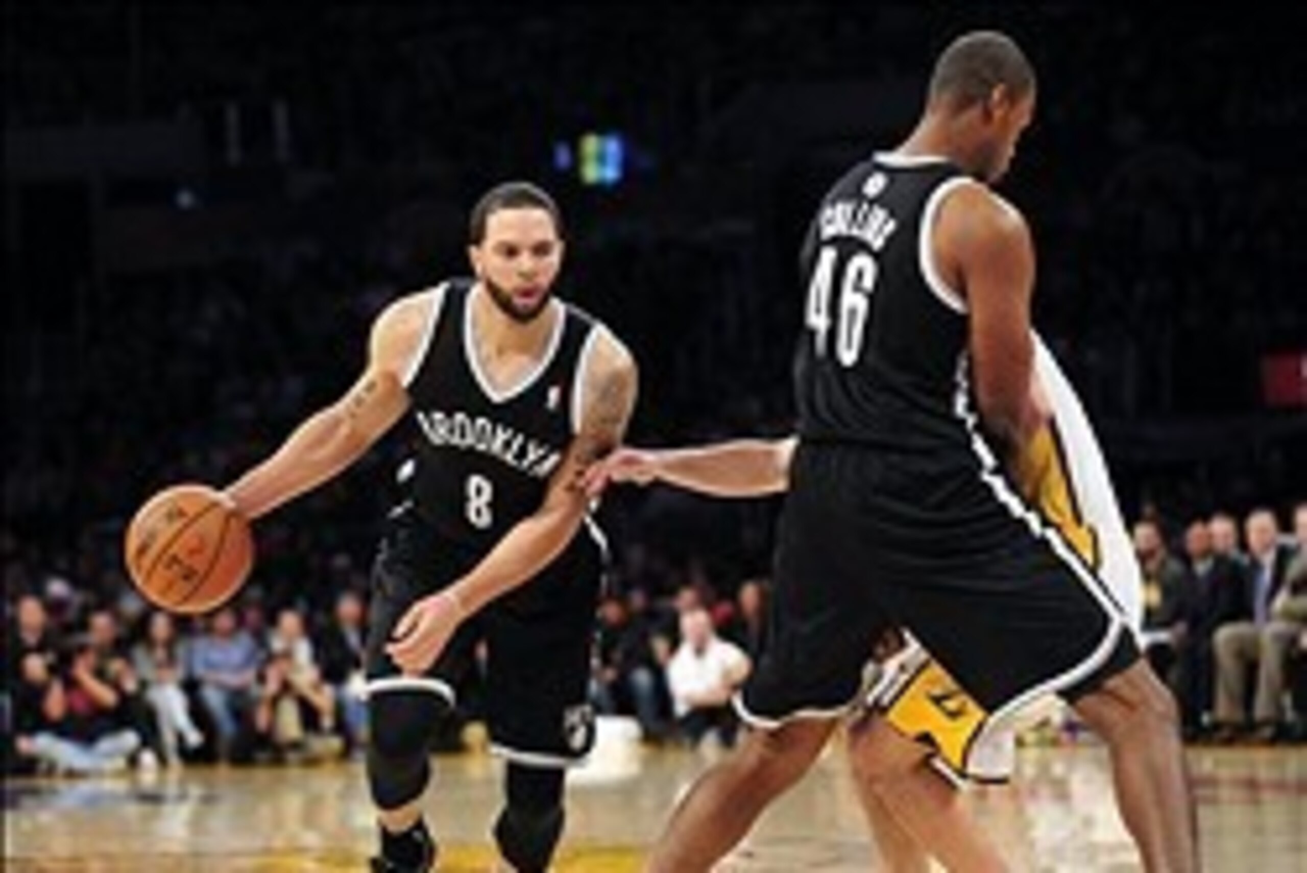 February 23, 2014; Los Angeles, CA, USA; Brooklyn Nets point guard Deron Williams (8) moves the ball as center Jason Collins (46) provides a screen against the Los Angeles Lakers during the first half at Staples Center. Mandatory Credit: Gary A. Vasquez-U