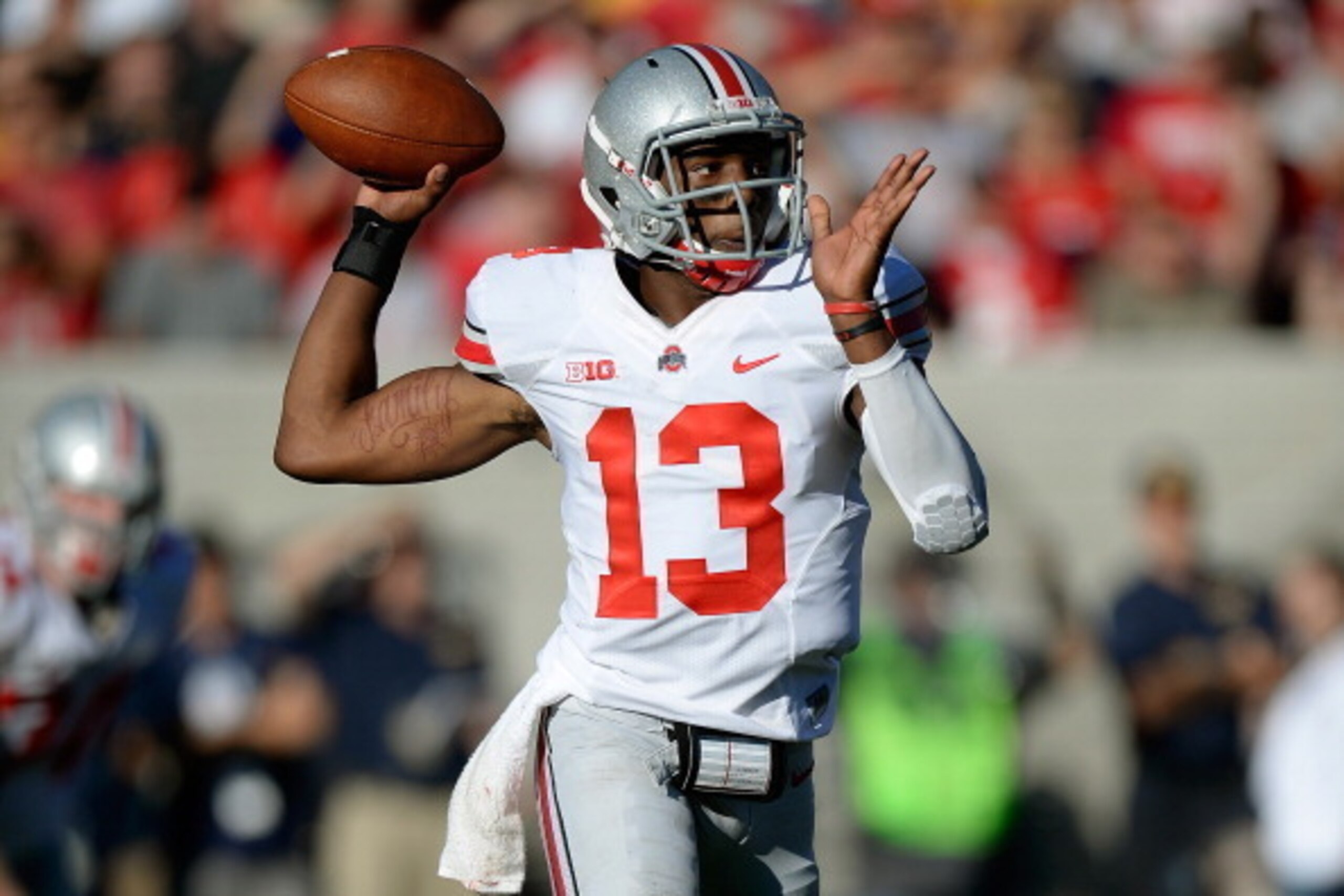 BERKELEY, CA - SEPTEMBER 14:  Kenny Guiton #13 of the Ohio State Buckeyes rolls out to pass during the second quarter against the California Golden Bears at California Memorial Stadium on September 14, 2013 in Berkeley, California.  (Photo by Thearon W. H