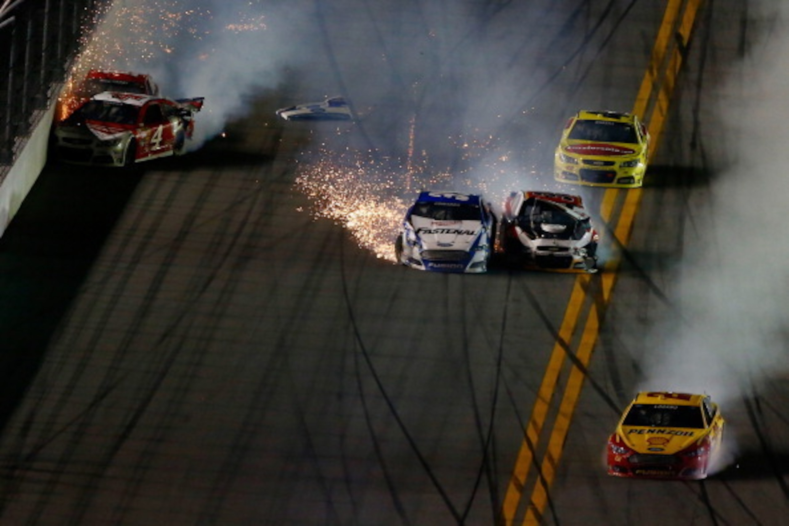 DAYTONA BEACH, FL - FEBRUARY 23:  Joey Logano, driver of the #22 Shell-Pennzoil Ford, Carl Edwards, driver of the #99 Fastenal Ford, Kevin Harvick, driver of the #4 Budweiser Chevrolet, Reed Sorenson, driver of the #36 Golden Corral Chevrolet, and Kyle Bu