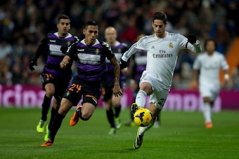 MADRID, SPAIN - NOVEMBER 30: Francisco Roman Alarcon (alias Isco) (R) of Real Madrid competes for the ball with Gilberto Garcia (alias Alcatraz) (L) of Real Valladolid CF during the La Liga match between Real Madrid CF and Real Valladolid CF at Estadio Sa