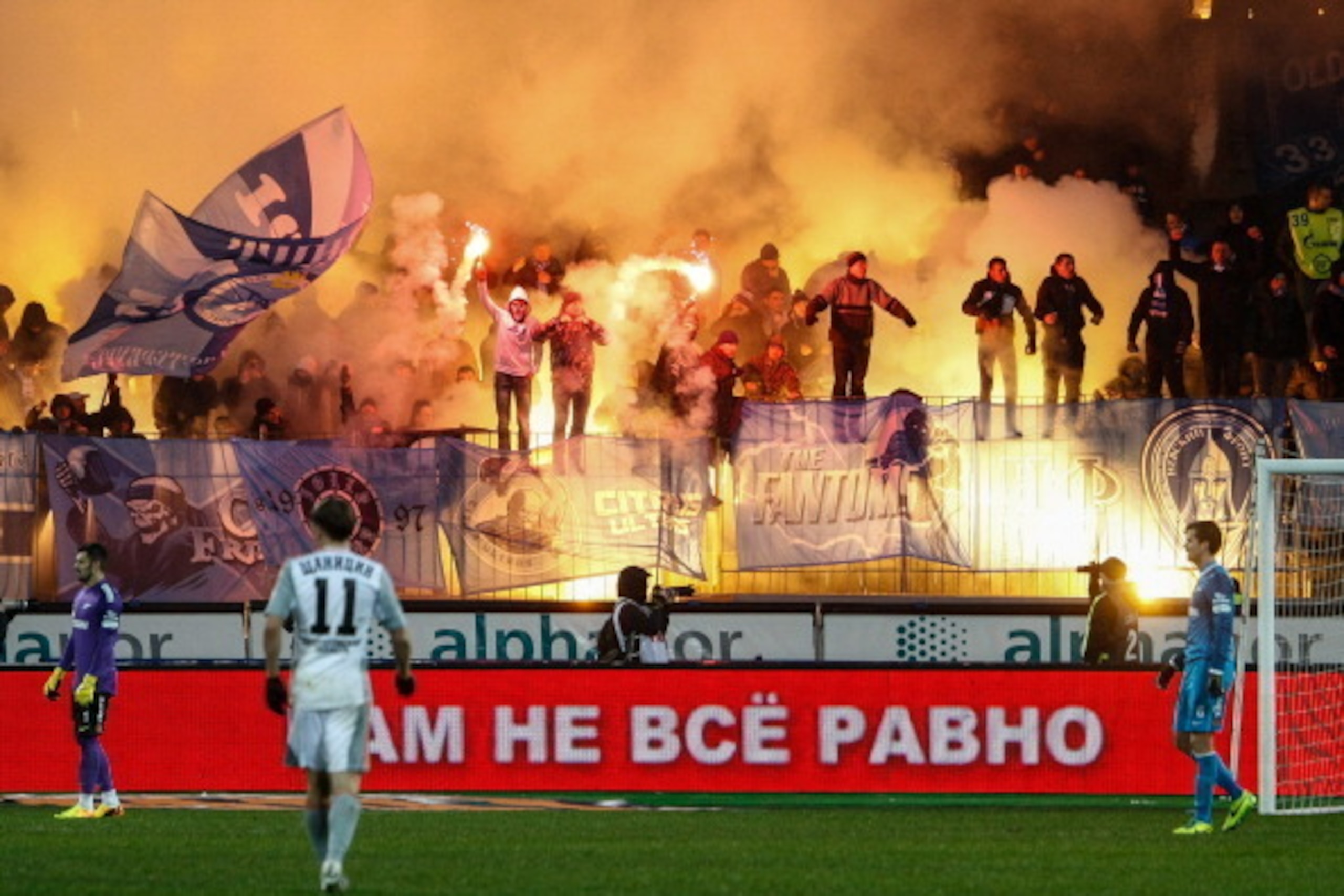 ST. PETERSBURG, RUSSIA - DECEMBER 06: Supporters of FC Zenit St. Petersburg light flares during the Russian Football League Championship match between FC Zenit St. Petersburg and FC Ural Sverdlovsk Oblast at the Petrovsky stadium on December 6, 2013 in St ST. PETERSBURG, RUSSIA - DECEMBER 06: Supporters of FC Zenit St. Petersburg light flares during the Russian Football League Championship match between FC Zenit St. Petersburg and FC Ural Sverdlovsk Oblast at the Petrovsky stadium on December 6, 2013 in St