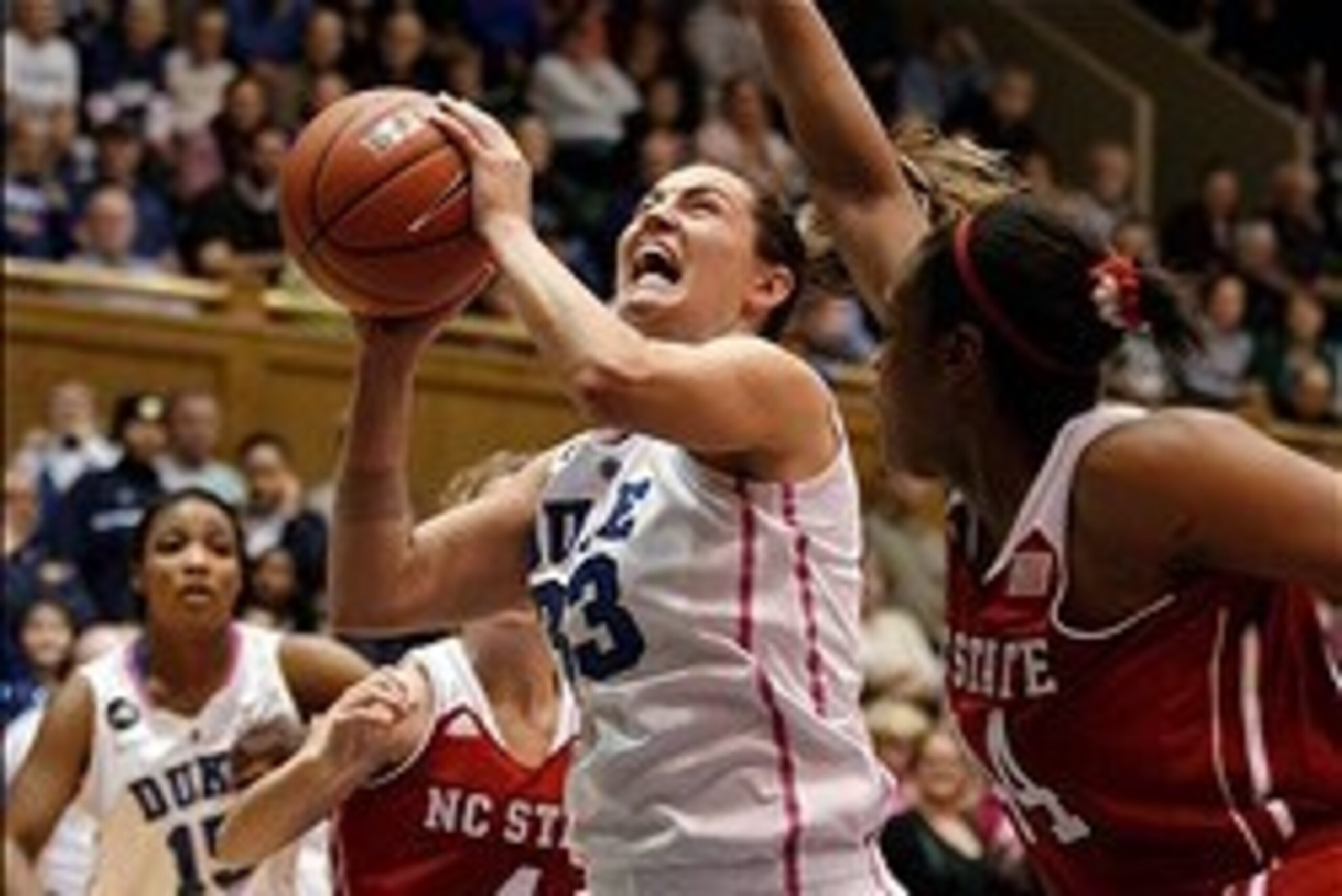 Feb 20, 2014; Durham, NC, USA; Duke Blue Devils guard/forward Haley Peters (33) drives against North Carolina State Wolfpack forward Kody Burke (44) at Cameron Indoor Stadium. Mandatory Credit: Mark Dolejs-USA TODAY Sports