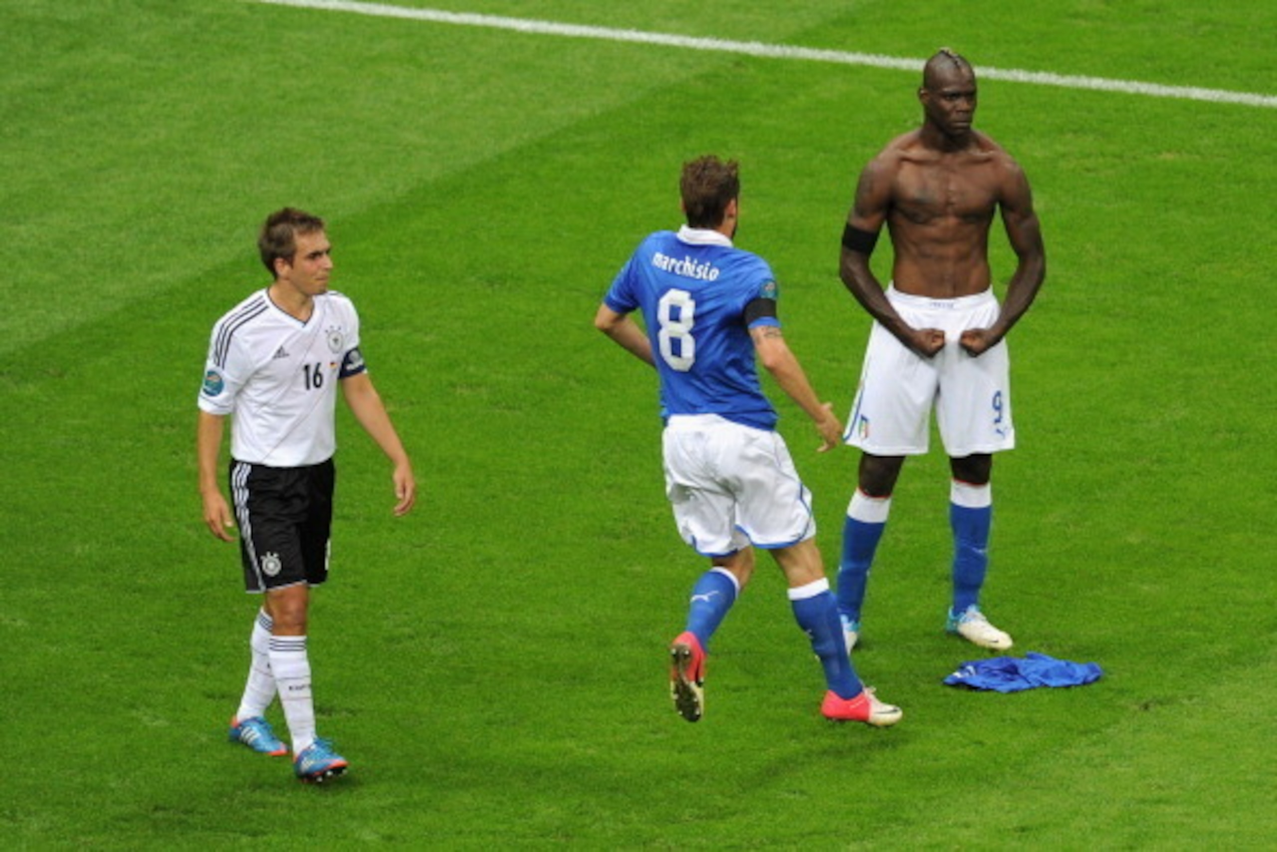 WARSAW, POLAND - JUNE 28: Mario Balotelli (R) of Italy celebrates with team-mate Claudio Marchisio after scoring his team's second goal as Philipp Lahm of Germany shows his dejection during the UEFA EURO 2012 semi final match between Germany and Italy at WARSAW, POLAND - JUNE 28: Mario Balotelli (R) of Italy celebrates with team-mate Claudio Marchisio after scoring his team's second goal as Philipp Lahm of Germany shows his dejection during the UEFA EURO 2012 semi final match between Germany and Italy at